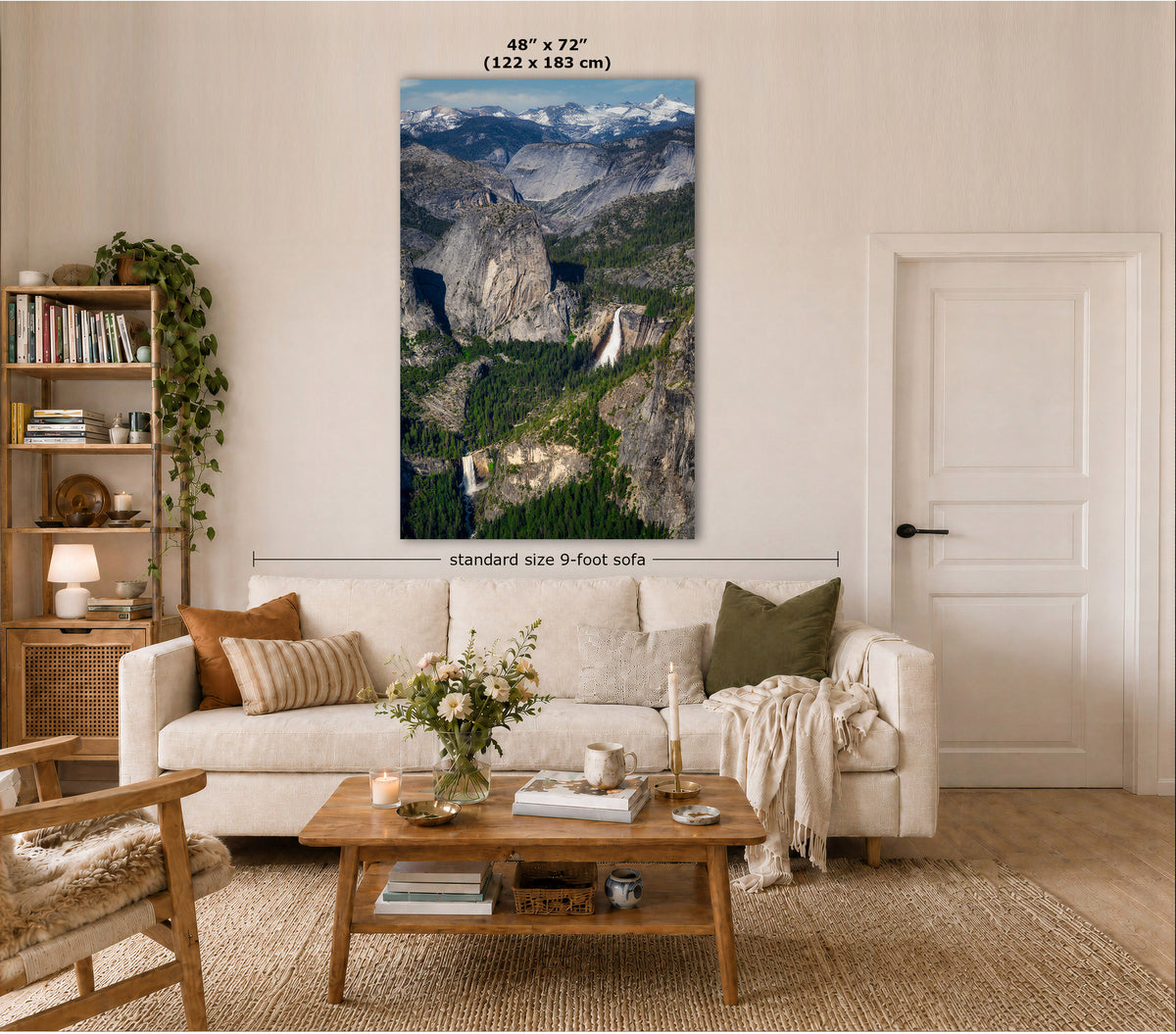 A vertical wall art print showing a mountain landscape with waterfalls, displayed above a white sofa in a styled living room. Text on the image indicates the print size as 48" x 72" (122 x 183 cm) and notes standard size 9-foot sofa.