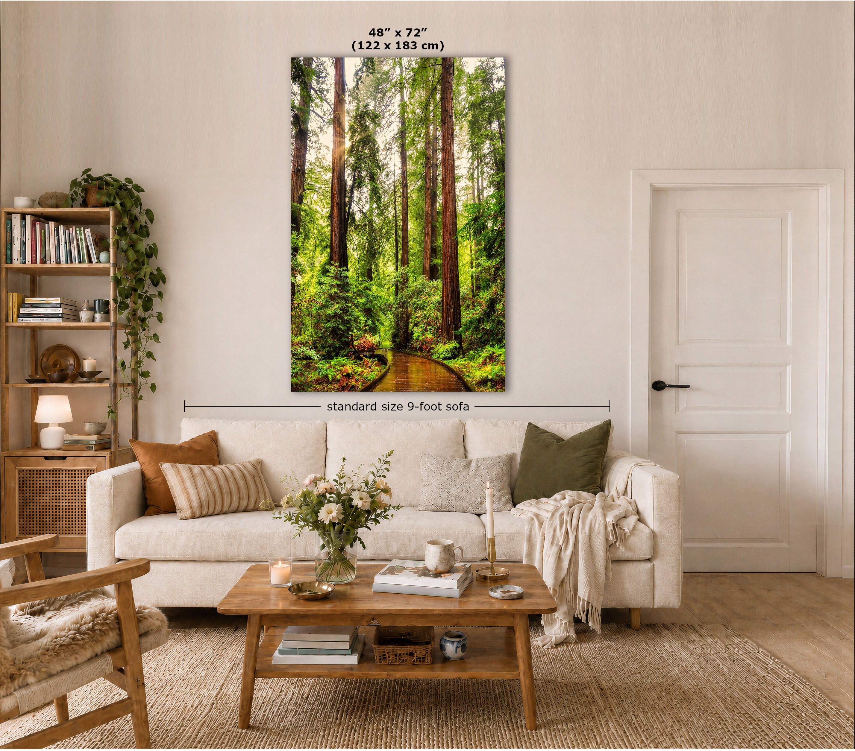 A vertical wall art print showing a lush green forest path with tall trees, displayed above a white sofa in a styled living room. The print includes size labels indicating 48" x 72" (122 x 183 cm) and a note about standard size 9-foot sofas.