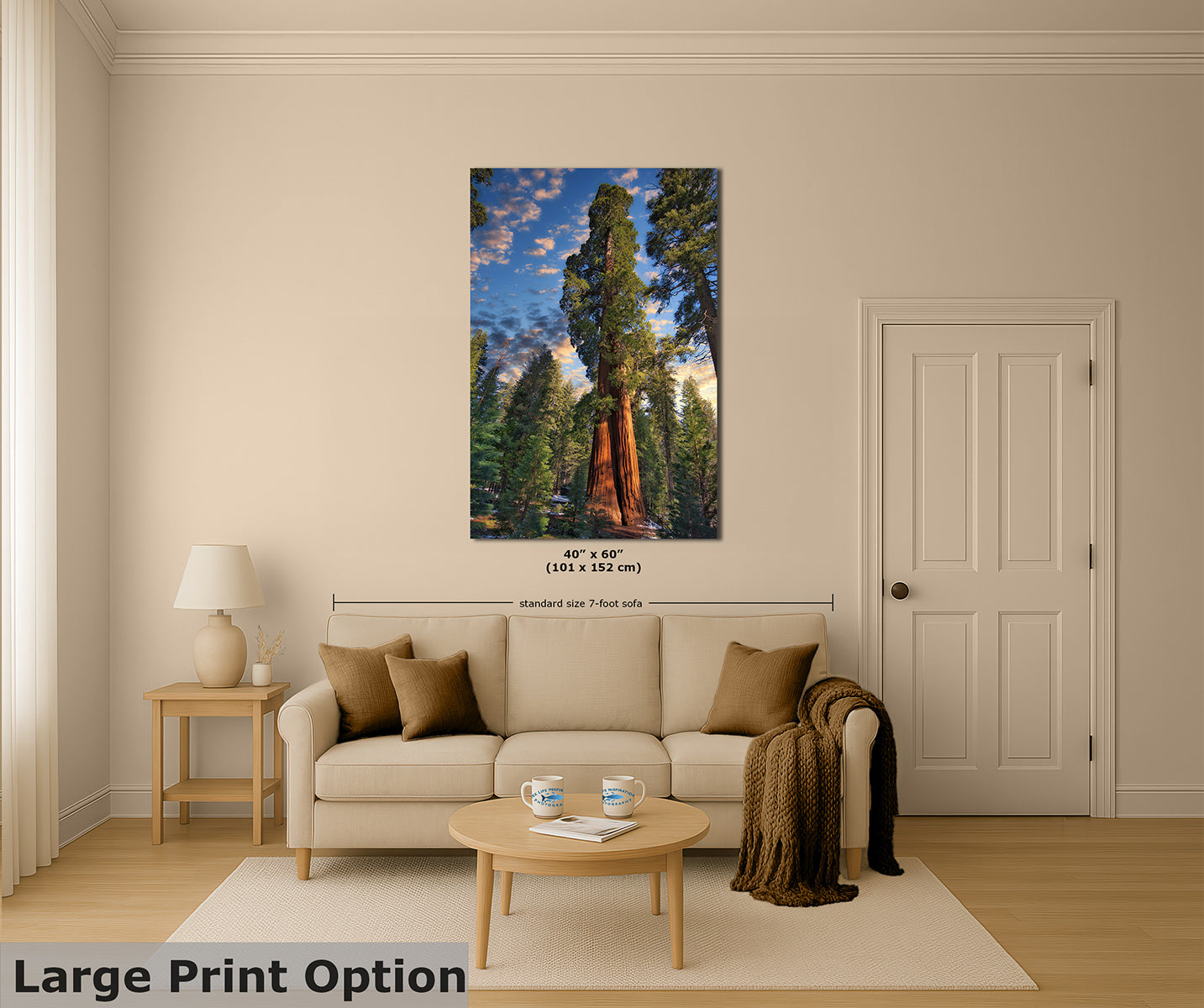 A large vertical wall art print showing a forest scene with a giant sequoia tree under a blue sky, displayed above a beige sofa in a styled living room. The print includes size text and a dimension line, and the image has a 'Large Print Option' label in the bottom left corner.
