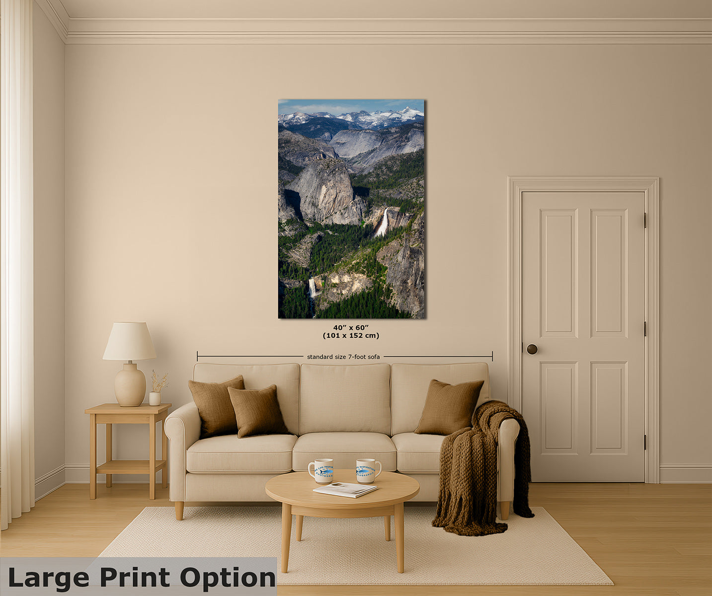 A large vertical print of a Yosemite mountain landscape with Nevada and Vernal waterfalls is displayed on a beige wall above a cream sofa in a staged living room. The image includes dimension markers and text reading 'Large Print Option' at the bottom left.