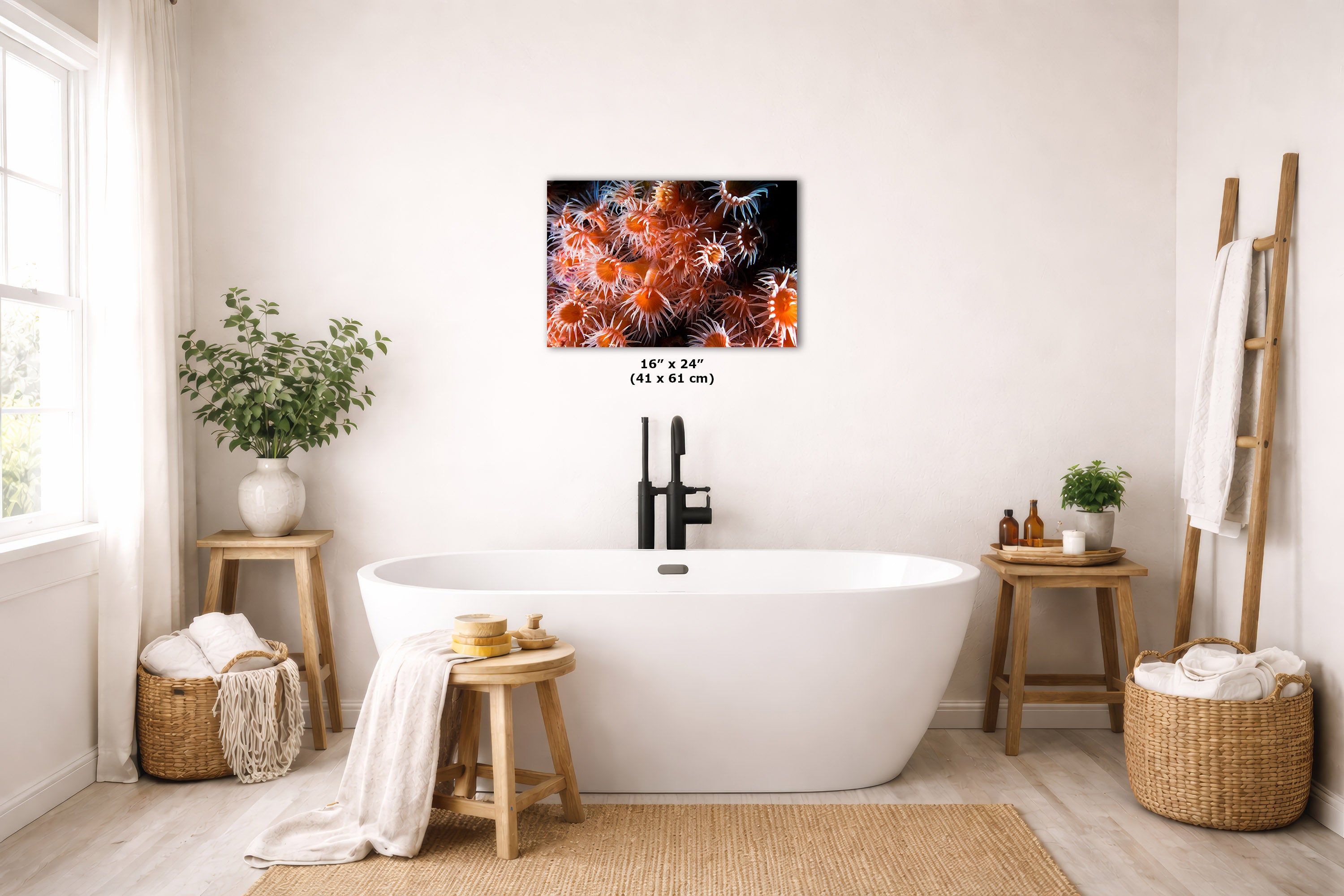 A wall art print depicting orange and red anemones on a dark background, displayed above a white freestanding bathtub in a bright, modern bathroom setting.