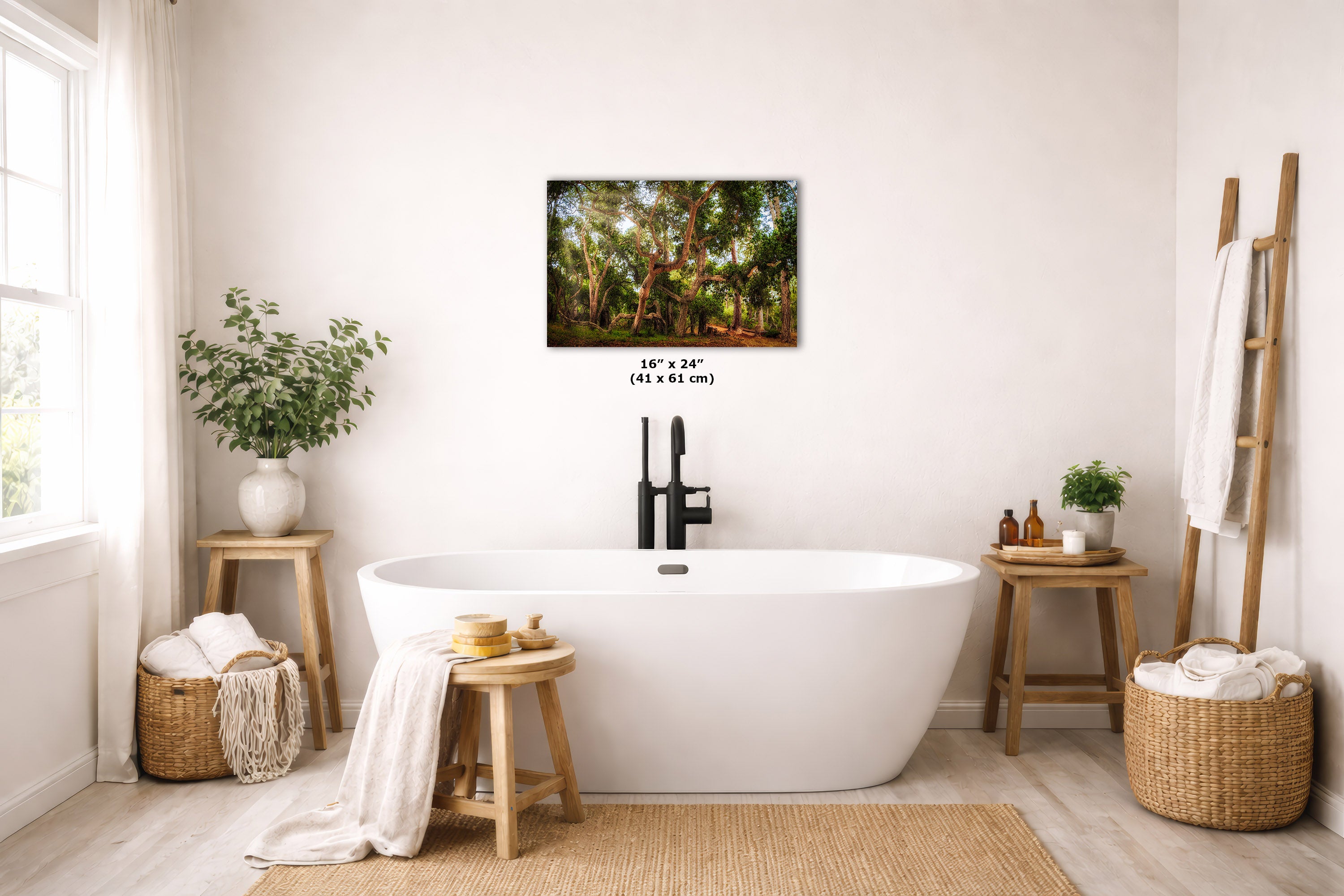 A framed wall art print depicting a lush green forest canopy is displayed above a white freestanding bathtub in a bright, modern bathroom. The print includes a size dimension overlay of 16 x 24 in.