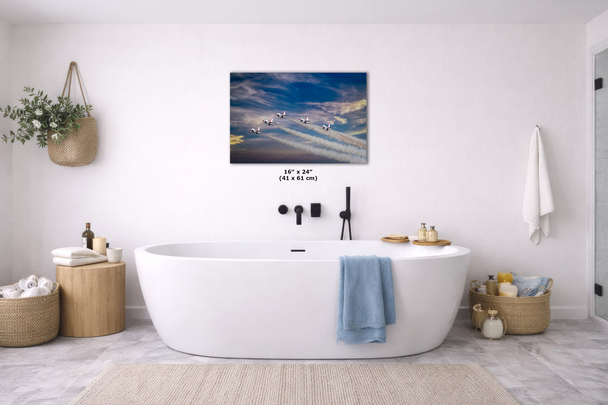A wall art print depicting a dramatic blue sky with the USAF Thunderbirds, styled in a bright, modern bathroom above a white freestanding bathtub.