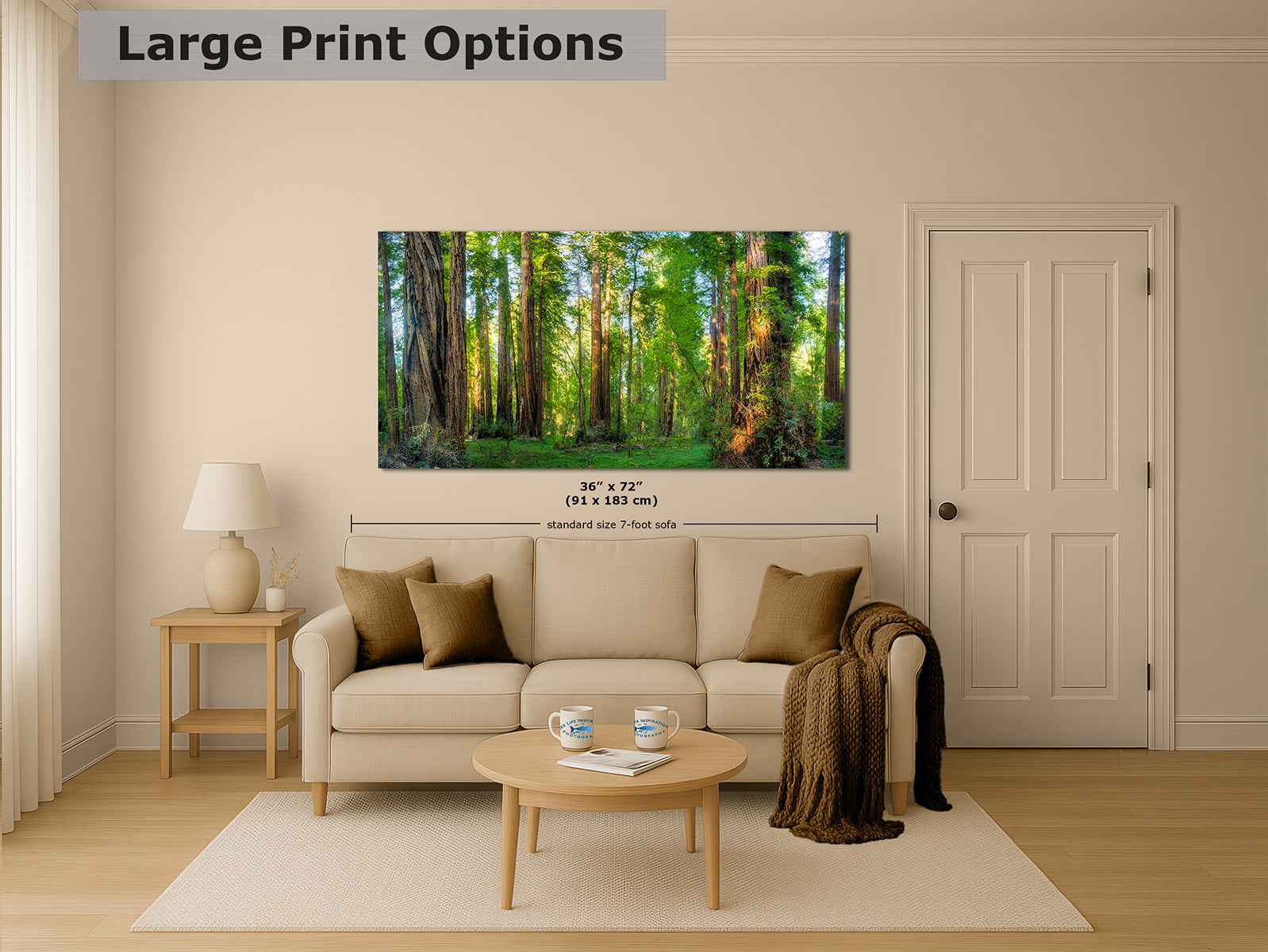 A living room mockup showing a large framed California Redwood forest art print mounted on a beige wall above a sofa. The print depicts tall green trees with warm sunlight.