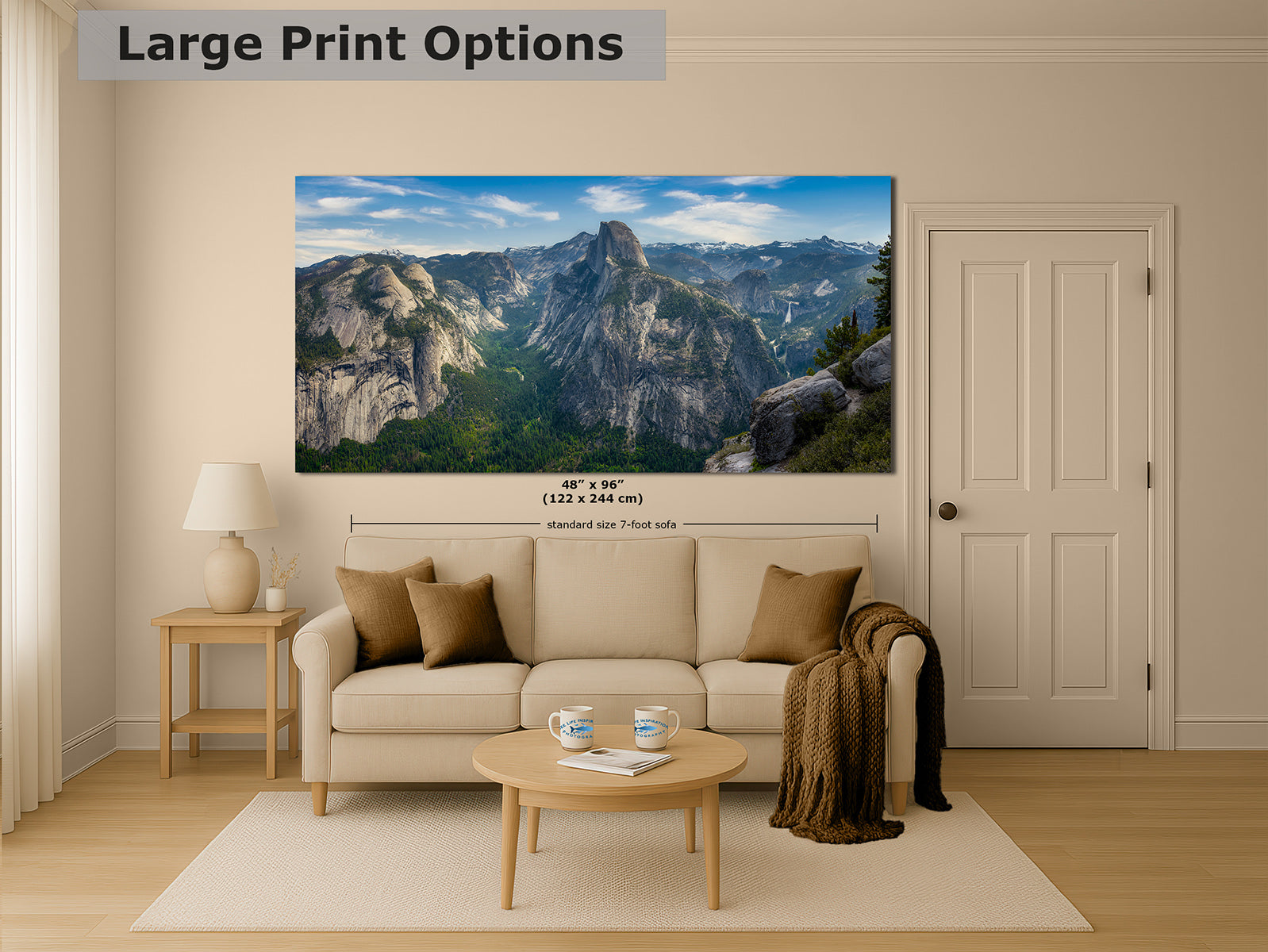 A large wall art print showing a Yosemite mountain landscape of Half Dome, displayed above a beige sofa in a styled living room. The print includes overlaid size information reading 48" x 96" (122 x 244 cm) and a note for a standard 7-foot wall.