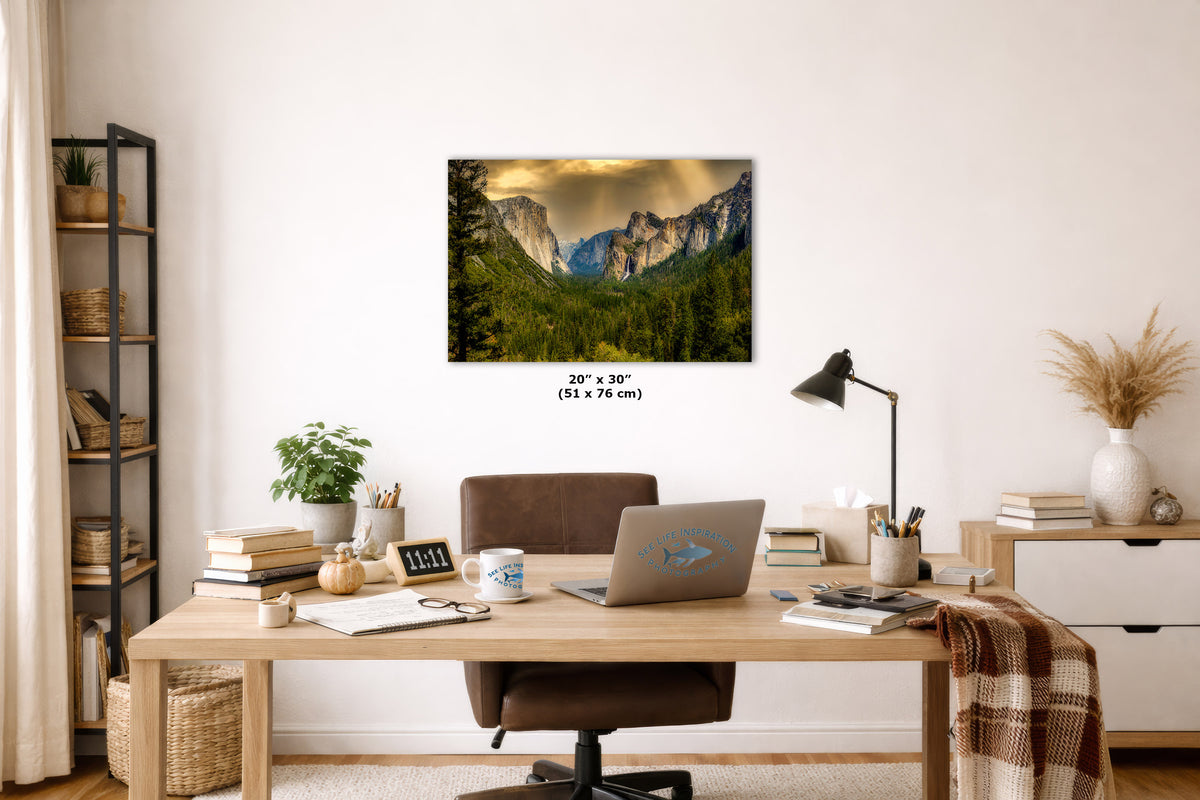 A wall art print showing a mountain valley landscape hangs above a wooden desk in a styled home office. The print is labeled 20 x 30 inches (51 x 76 cm).