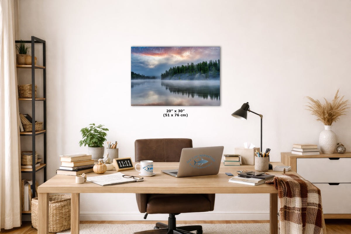 A wall art print showing a misty forest lake at sunrise hangs above a wooden desk in a styled home office. The print is labeled 20 x 30 inches (51 x 76 cm).