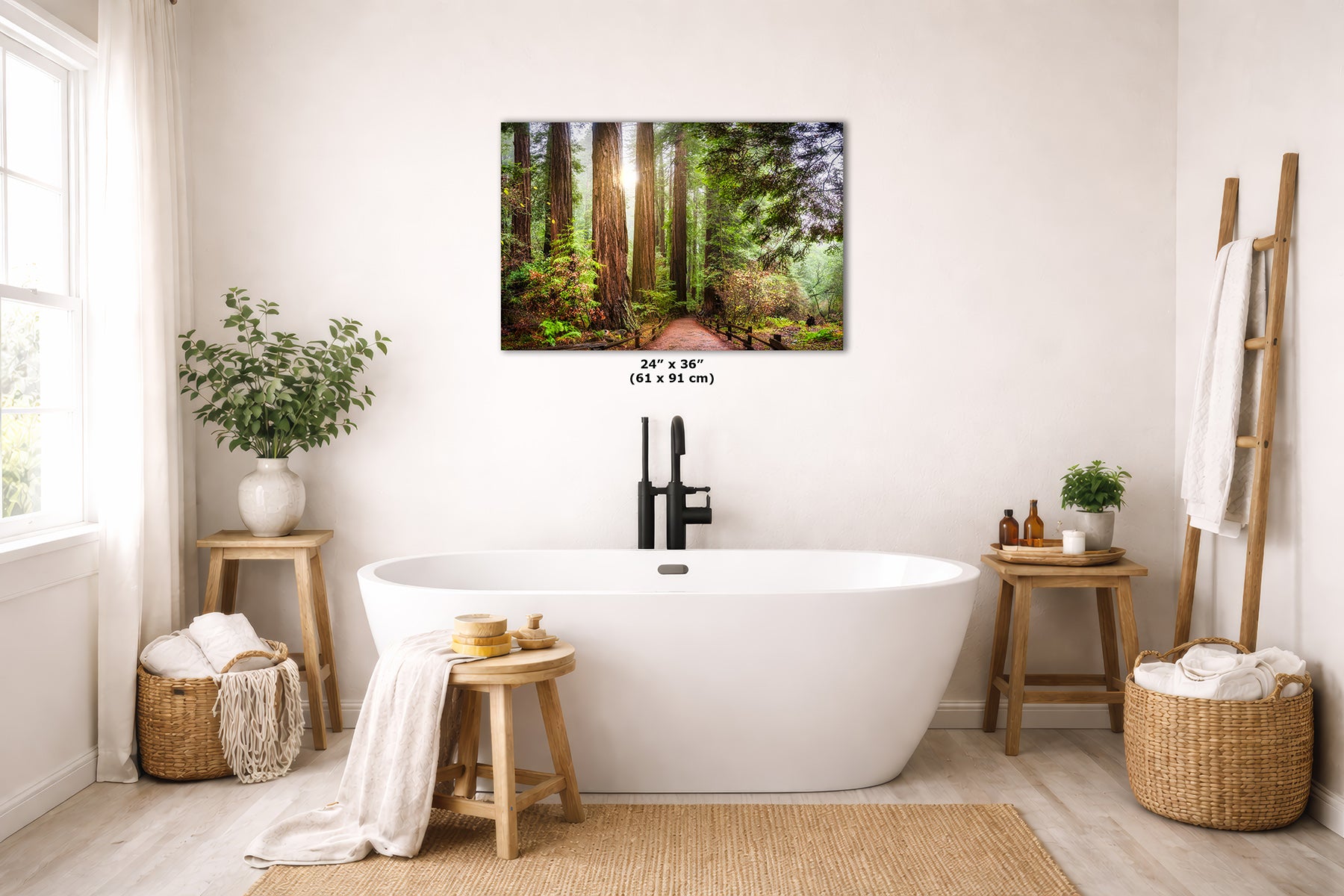 A California Redwood forest wall art print hangs above a white freestanding bathtub in a bright, modern bathroom. The print shows a sunlit woodland path with tall trees and green undergrowth.