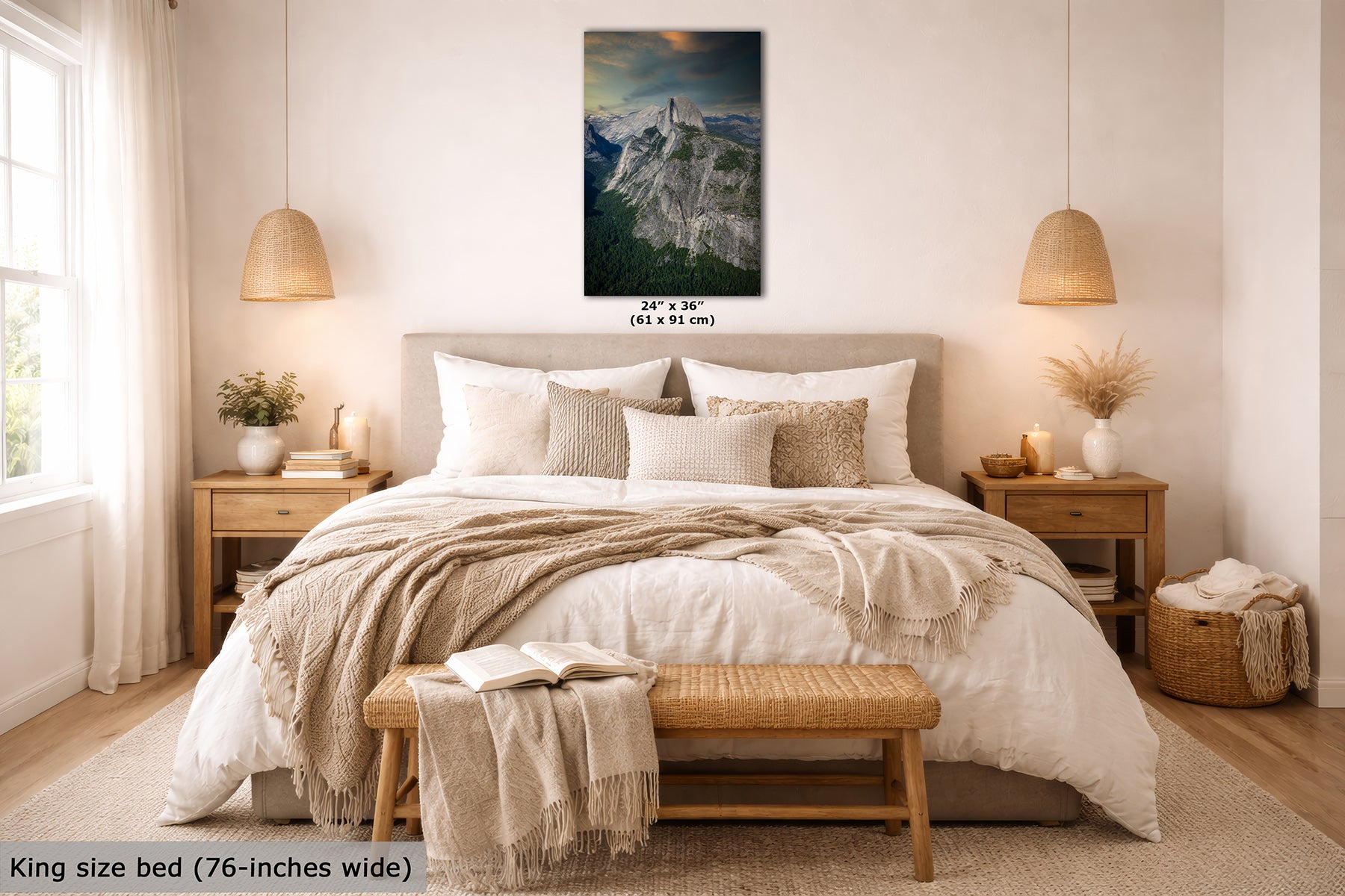 A wall art print showing a mountain landscape, Half Dome in Yosemite, is displayed above a neatly made bed in a bright, modern bedroom. The print includes size text reading 24" x 36" (61 x 91 cm), and the image also includes a text label at the bottom left stating King size bed (76-inches wide).