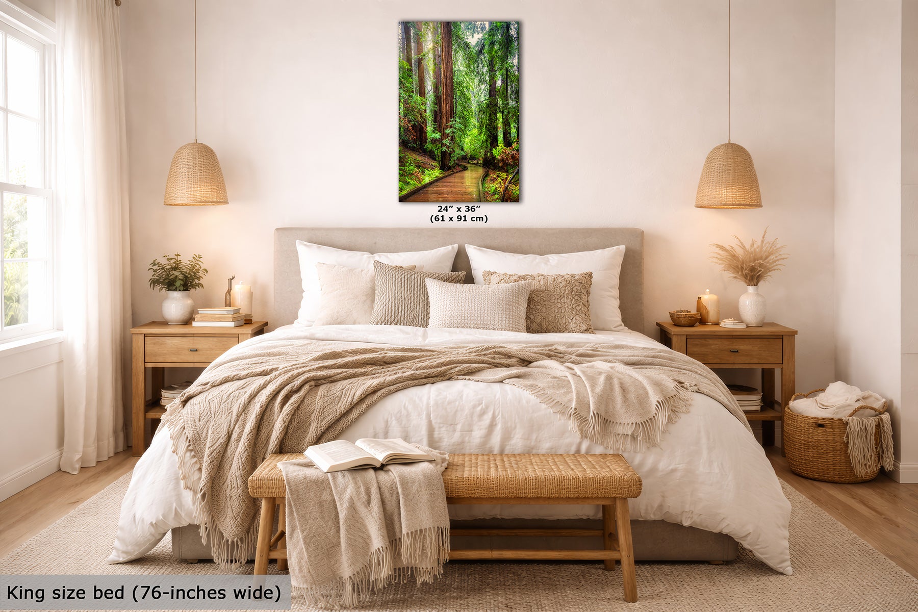 A Redwood forest wall art print hangs above a neatly made bed in a bright, modern bedroom. The artwork shows a sunlit forest path with tall trees and green foliage.