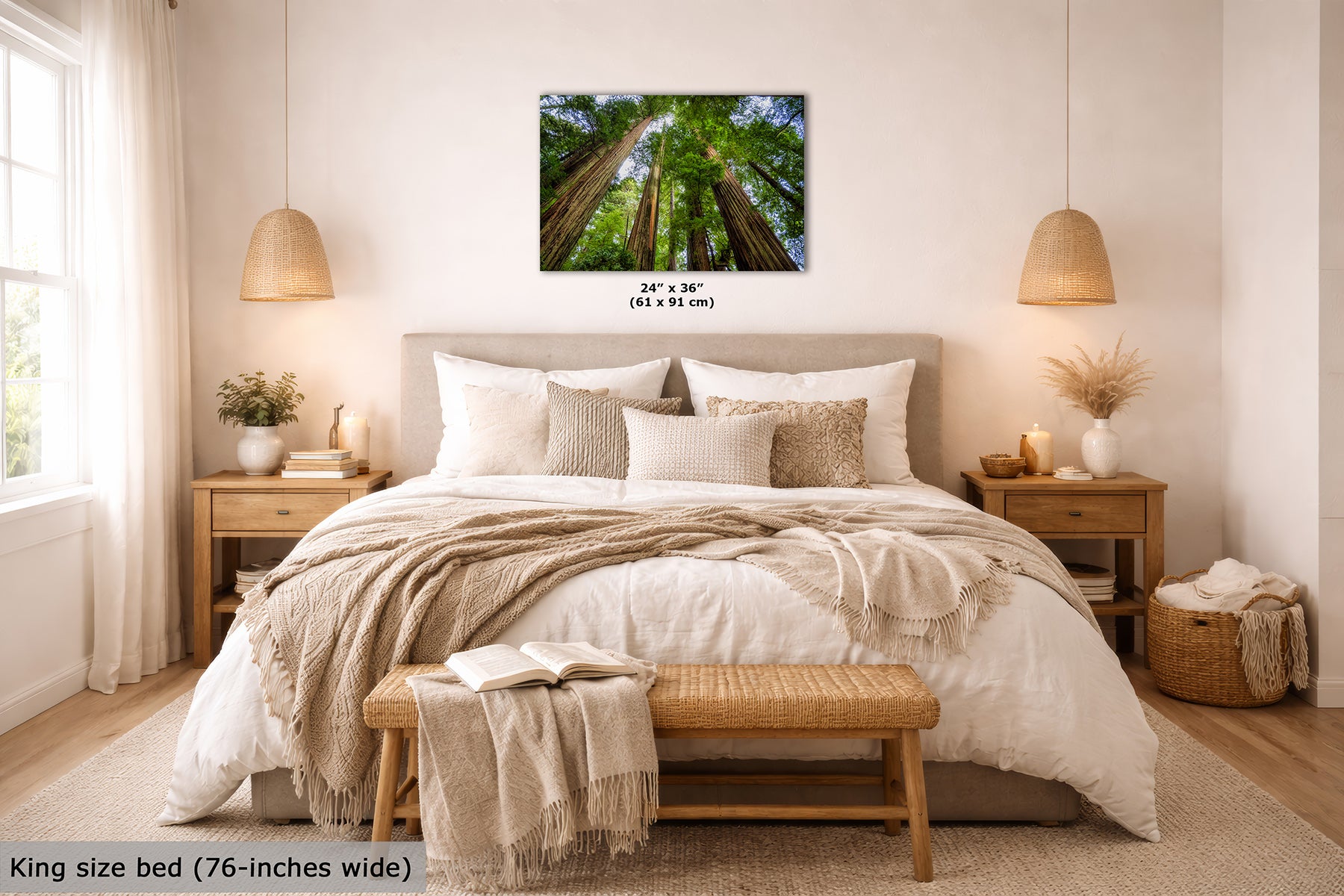 A framed wall art print showing a forest of redwood trees viewed from below, displayed above a king-size bed in a styled bedroom. The print includes size text reading 24" x 36" (61 x 91 cm) and a text overlay at the bottom left reading King size bed (76-inches wide).