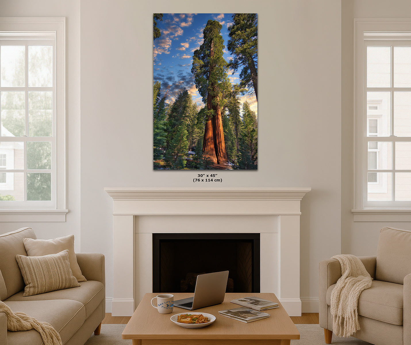 A vertical canvas wall art print depicting giant sequoia trees under a blue sky, displayed in a mockup living room above a white fireplace mantel.