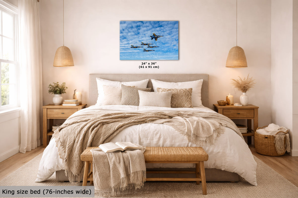 A wall art print showing a blue sky with military jets is displayed above a neatly made bed in a bright, modern bedroom. The print includes size text reading 24" x 36" (61 x 91 cm), and the scene also includes a bed description noting king size bed (76-inches wide).