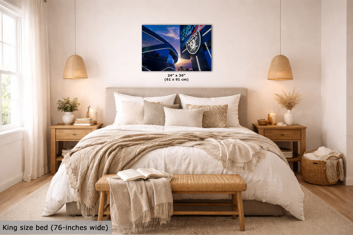 A wall art print showing a blue-toned night street scene with a horse and carriage, displayed above a neatly made bed in a bright, modern bedroom. The print includes size text reading 24" x 36" (61 x 91 cm).