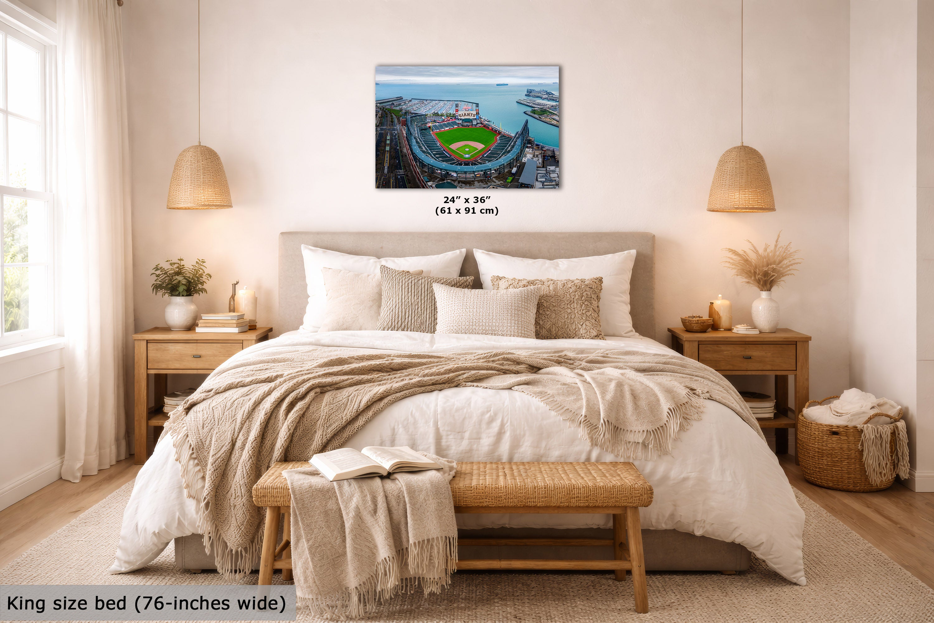 A Oracle Park marina wall art print showing an aerial view of a stadium and harbor is displayed above a neatly made bed in a bright, modern bedroom. The print includes size text reading 24" x 36" (61 x 91 cm).