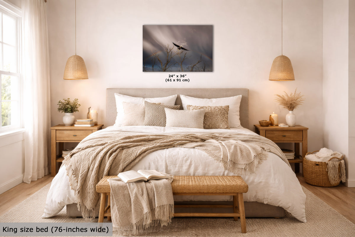 A wall art print showing a moody dark blue sky, displayed above a neatly made bed in a warm, modern bedroom. The print includes size text reading 24" x 36" (61 x 91 cm).
