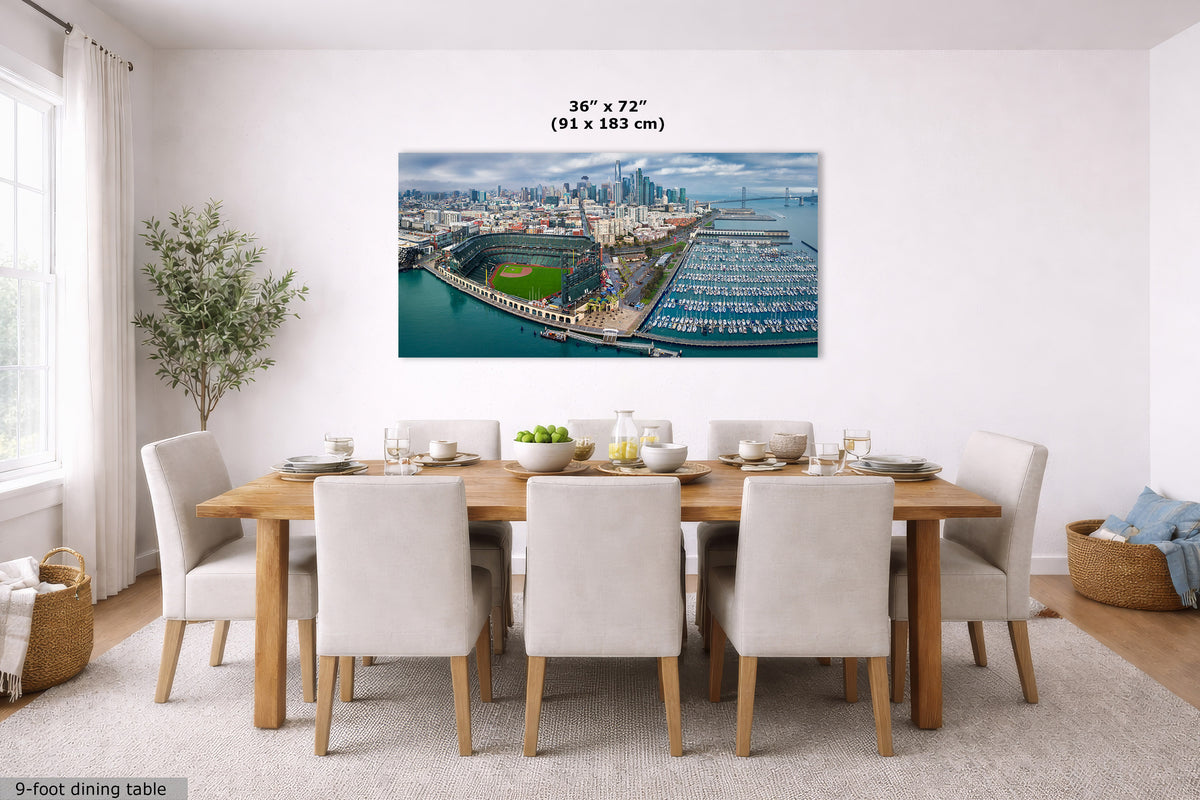 A large Oracle Park skyline panorama wall art print showing an aerial view of San Francisco, hung above a dining table in a bright modern dining room. The print includes size text reading 36 x 72 inches (91 x 183 cm).