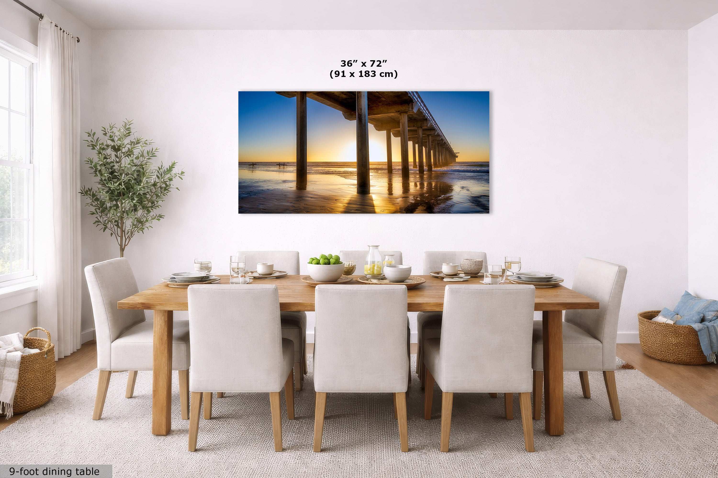 A wall art print showing a pier over water at sunset, displayed above a dining table in a bright modern dining room. The print includes size text reading 36 x 72 inches (91 x 183 cm).