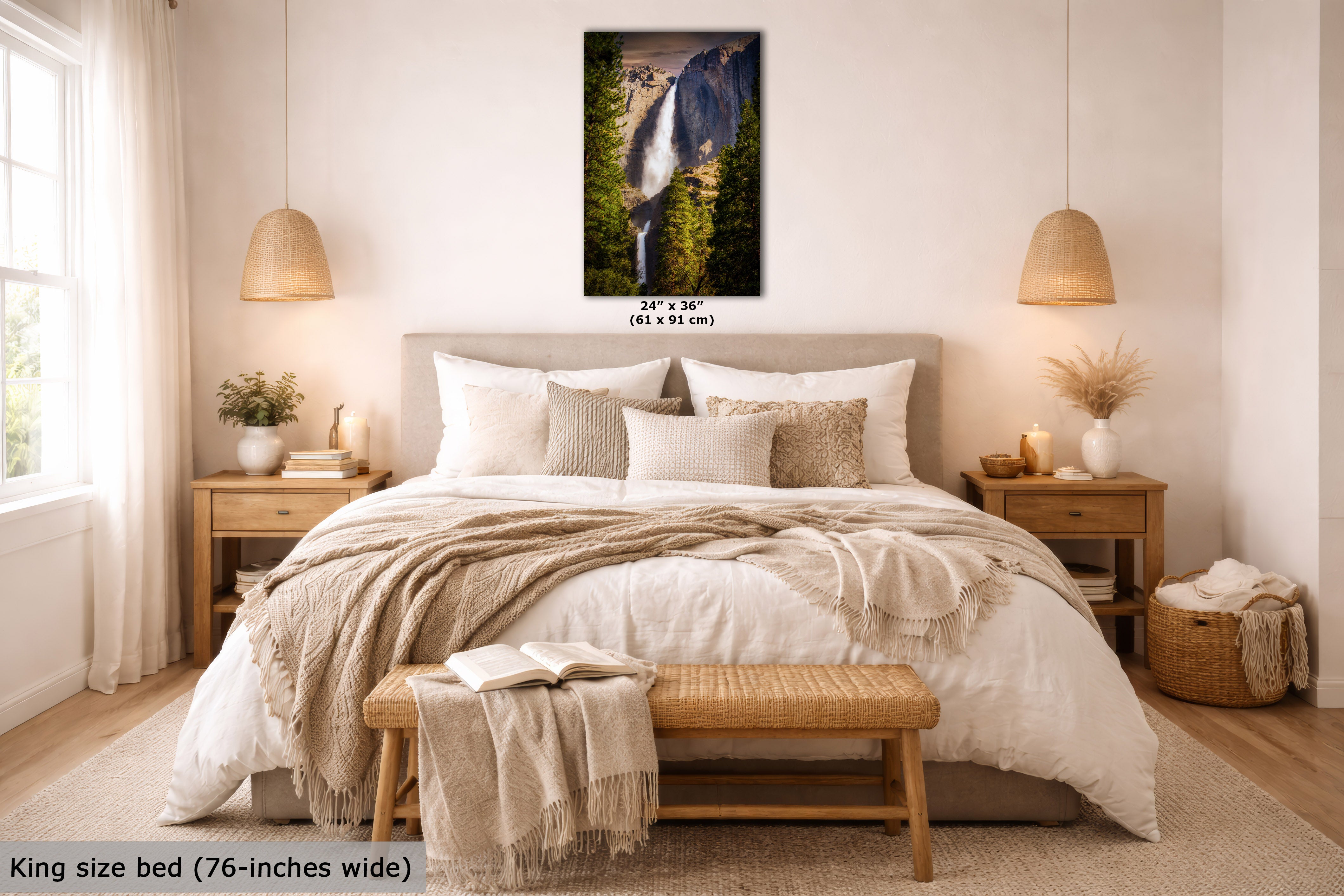 A framed vertical wall art print of a waterfall in a forest hangs above a bed in a styled bedroom. The print is shown as the product, with the bed and room serving as lifestyle context.