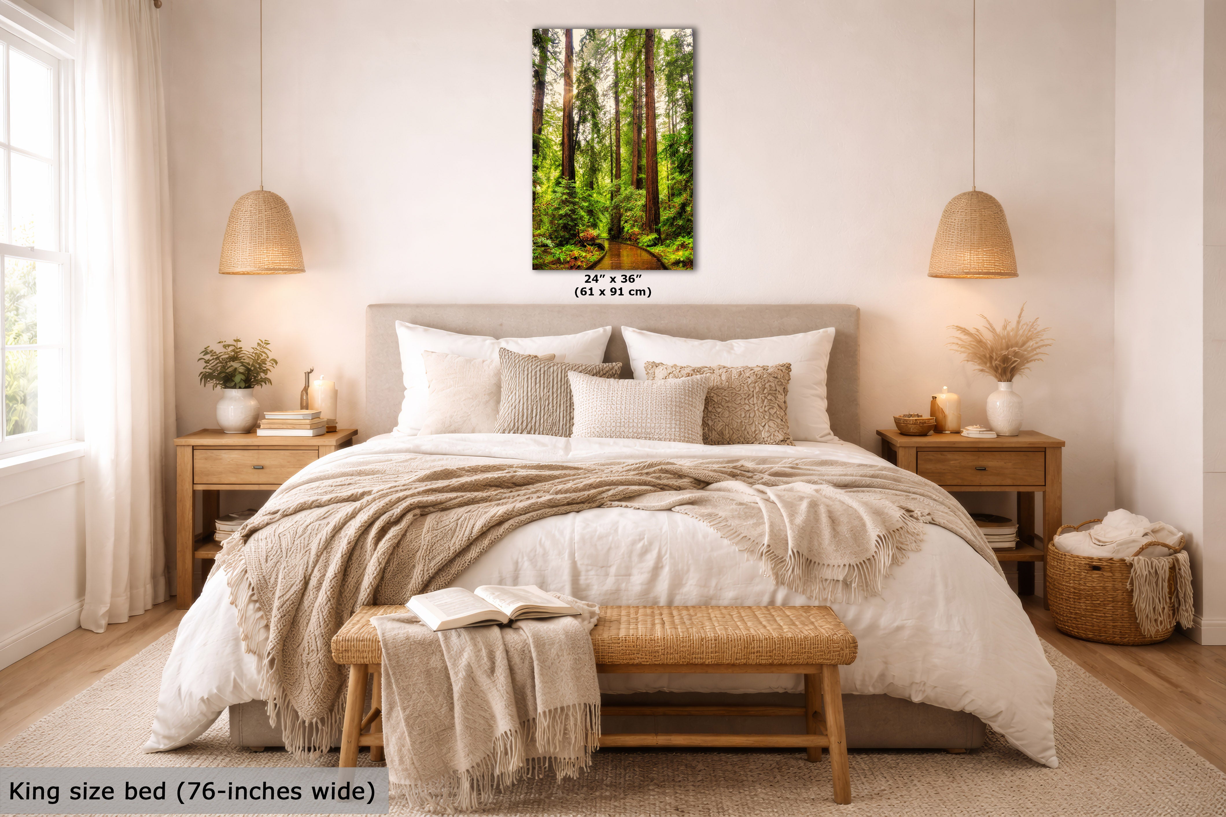 A vertical forest wall art print displayed above a neatly made bed in a bright, modern bedroom. The print shows a lush green woodland scene with tall trees.