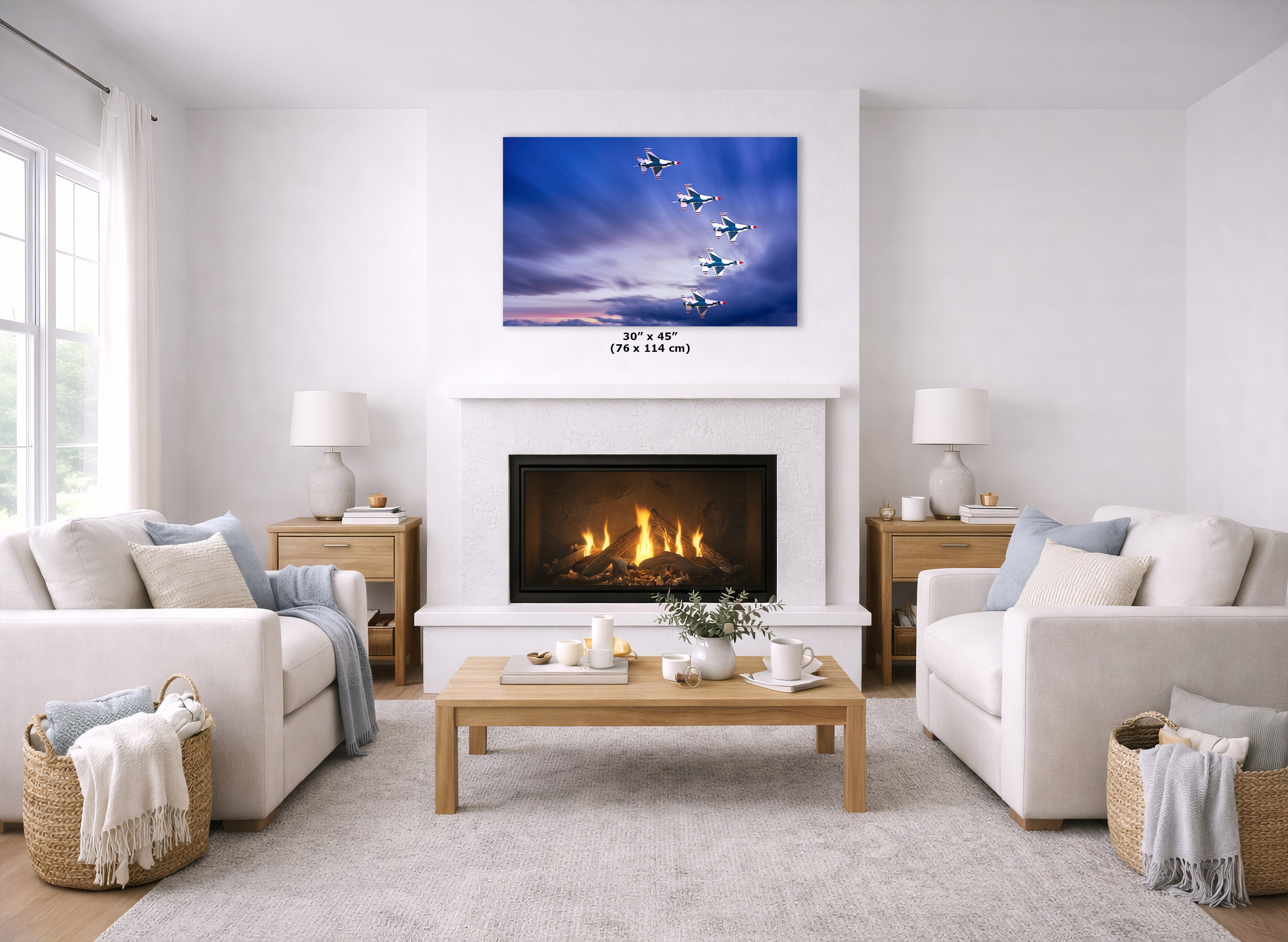 A canvas wall art print depicting a blue sky with flying jets and a sunset, displayed above a white fireplace in a bright, modern living room setting.