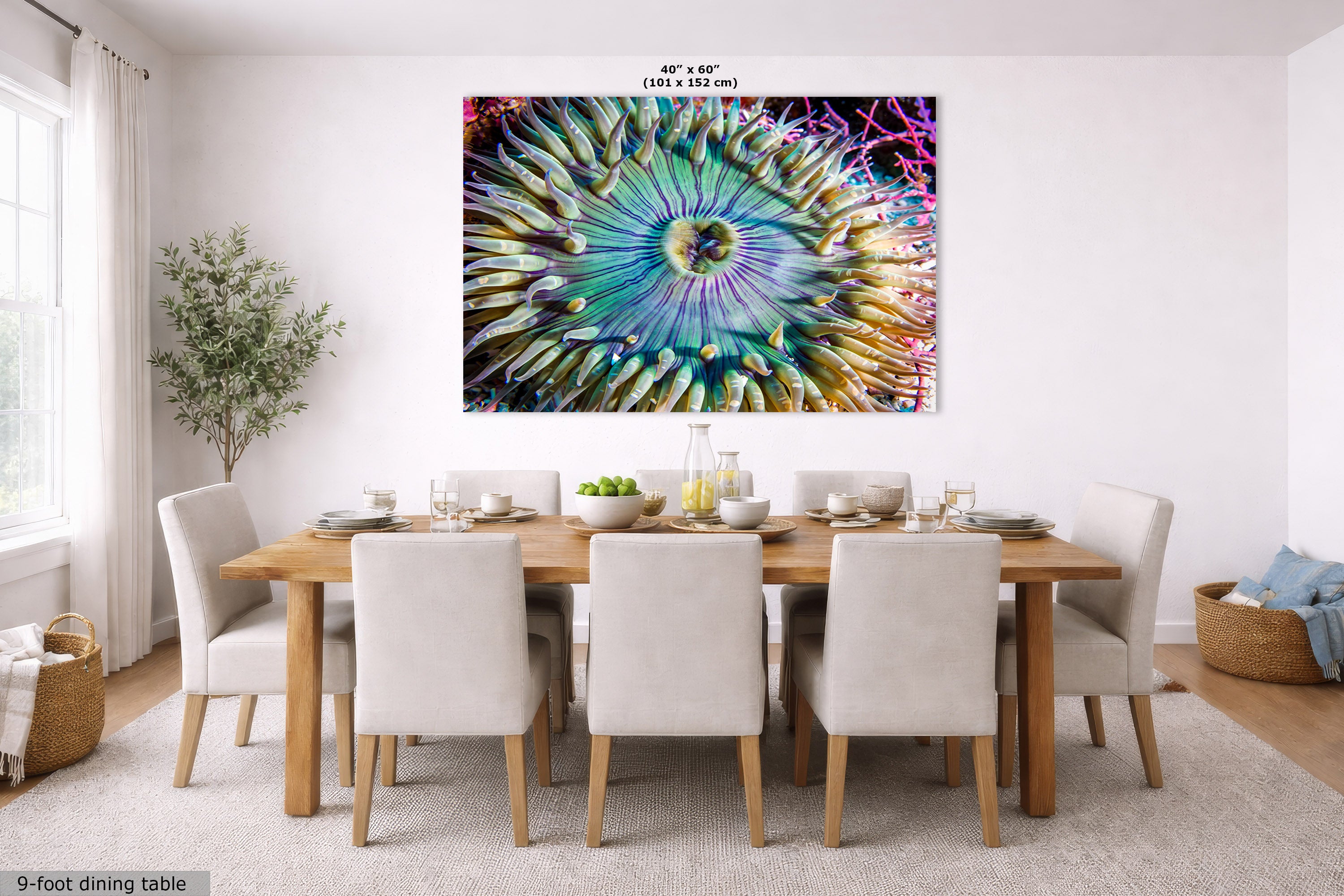 A large square wall art print showing a colorful abstract anemone, displayed above a dining table in a bright modern dining room. The print includes size text at the top and a small label in the corner about the 9-foot dining table.