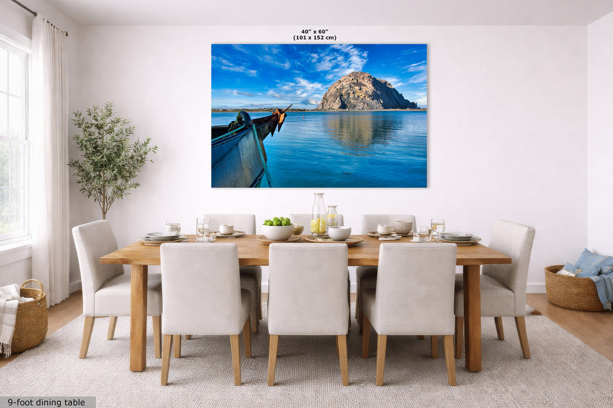 Dining room with a large wall art of a coastal scene with a boat.