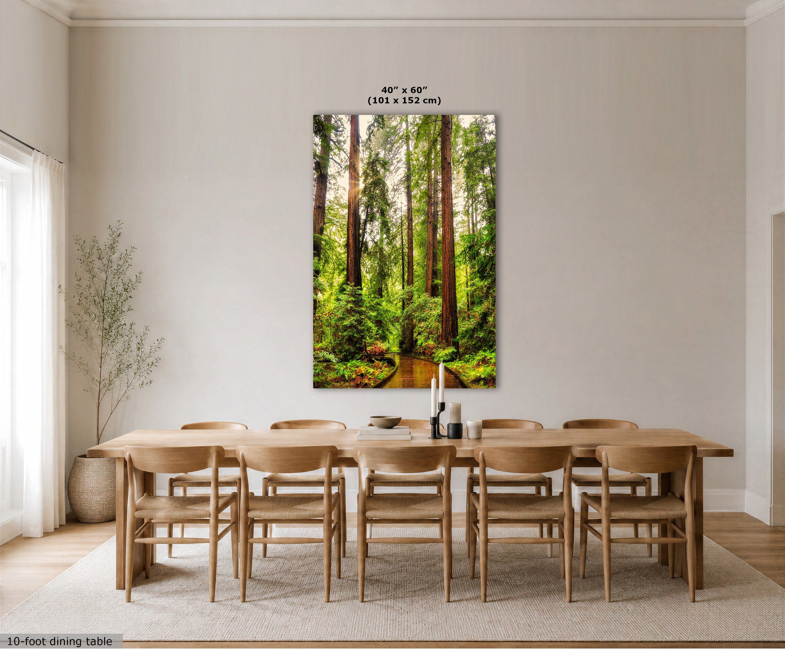 A vertical wall art print depicting a lush green forest with tall trees, displayed in a dining room setting above a wooden dining table and chairs. The print includes a size overlay indicating 40" x 60" (101 x 152 cm).