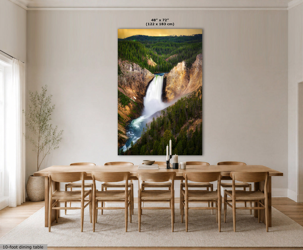 A large vertical wall art print showing a waterfall in a forest canyon, displayed above a wooden dining table and chairs in a bright modern dining room. The print includes size text at the top reading 48" x 72" (122 x 183 cm).