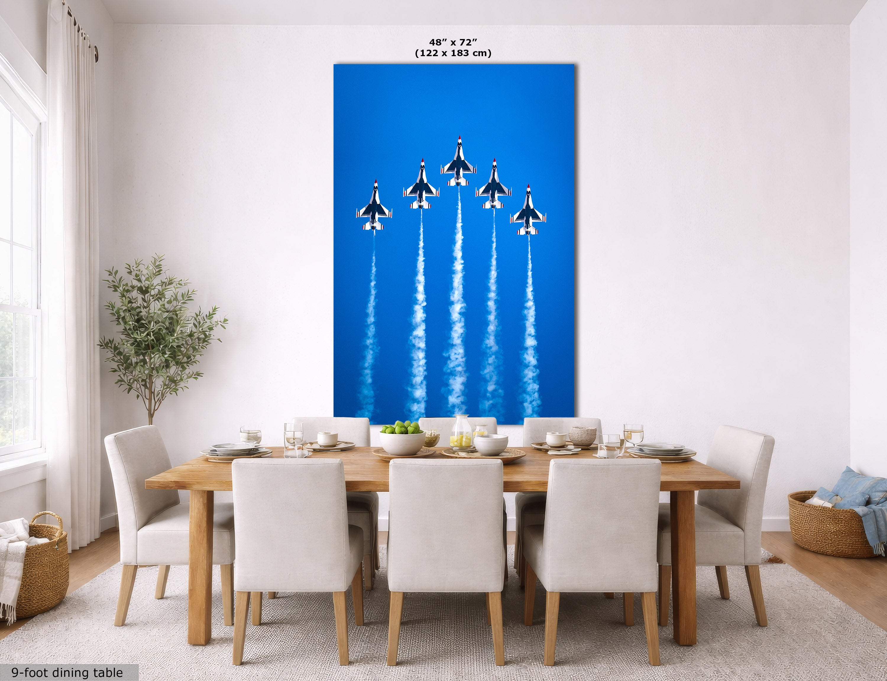 A large vertical wall art print showing five fighter jets flying upward against a bright blue sky, displayed above a wooden dining table in a modern dining room. The print includes size text at the top and a small note at the bottom left.