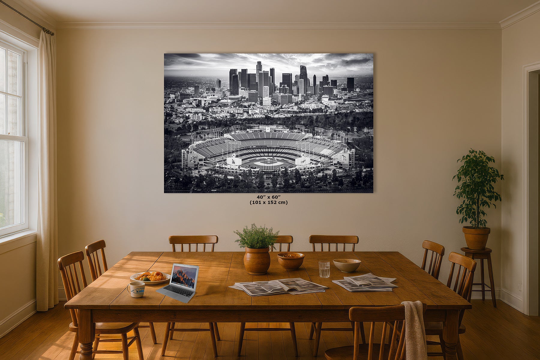 40x60 inch grayscale print of Dodger Stadium and the Los Angeles skyline above a wooden dining table, black and white baseball wall art