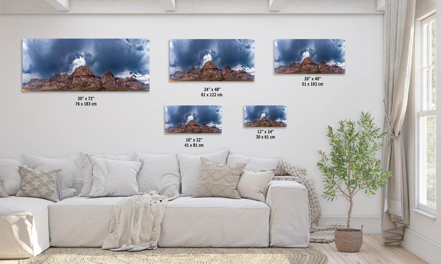 a living room with a white couch and three pictures on the wall