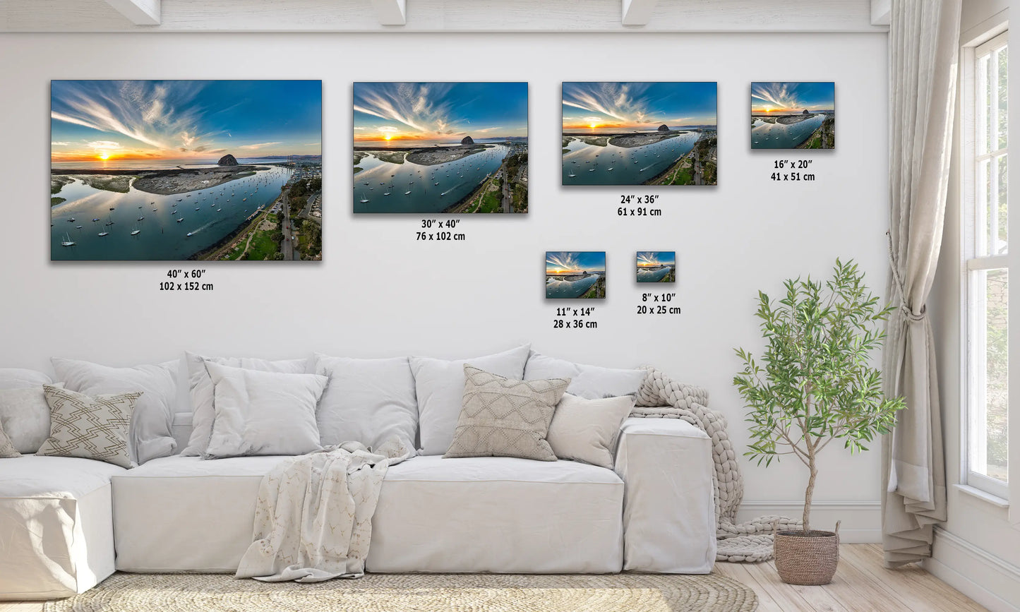 a living room with a white couch and paintings on the wall