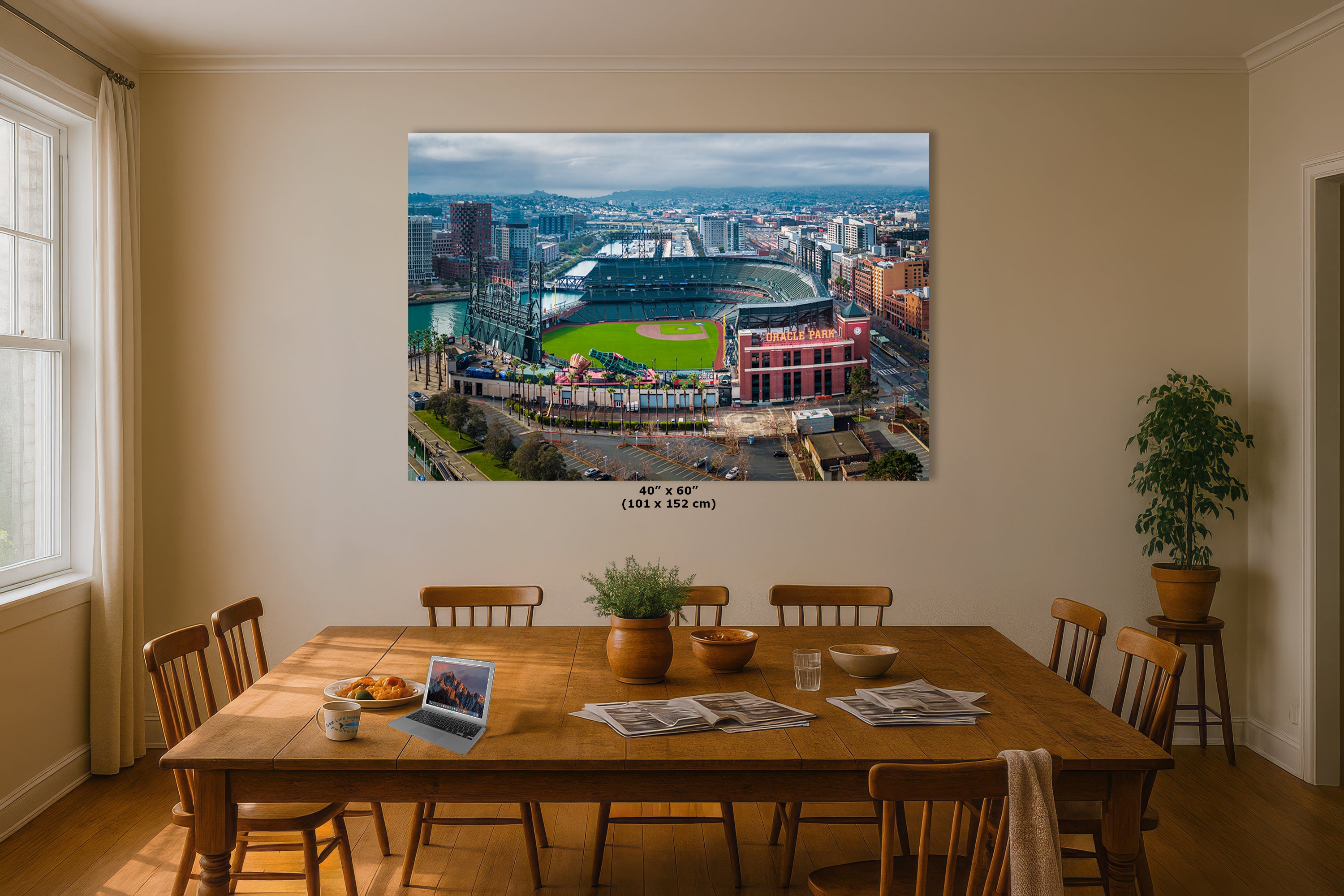 a large, colorful aerial view of a city, with a baseball stadium in the center. The cityscape is surrounded by buildings and roads, creating a vibrant urban landscape.