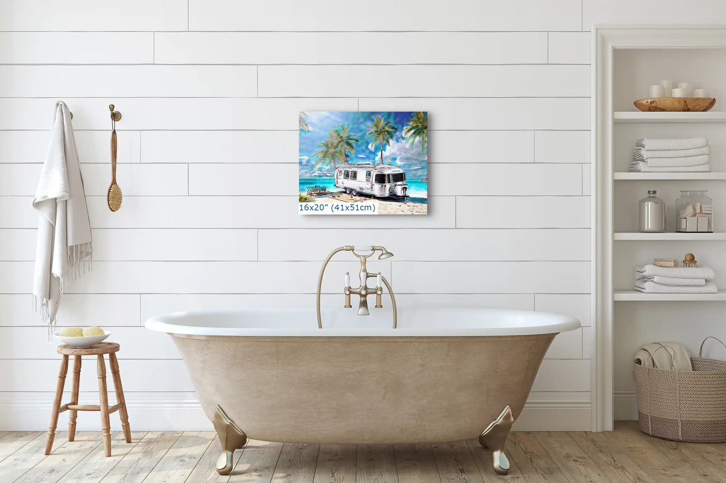 Small 16x20-inch wall art of an Airstream on a sunny tropical beach, enhancing the decor above a vintage bathtub.
