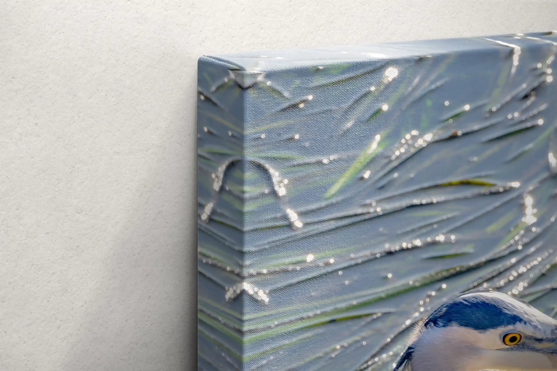 Detailed close-up of the canvas texture showing the fine print quality of the great blue heron image and the water ripples.