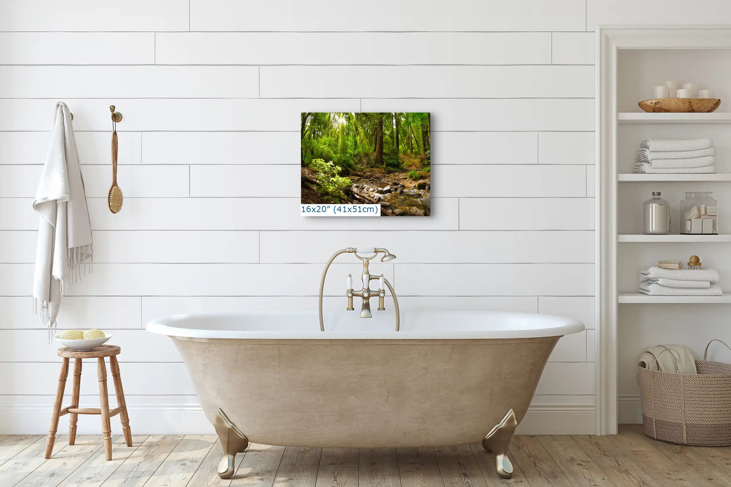 A canvas print sized 16x20 inches, placed above a bathtub, showing a vibrant forest scene with a creek.
