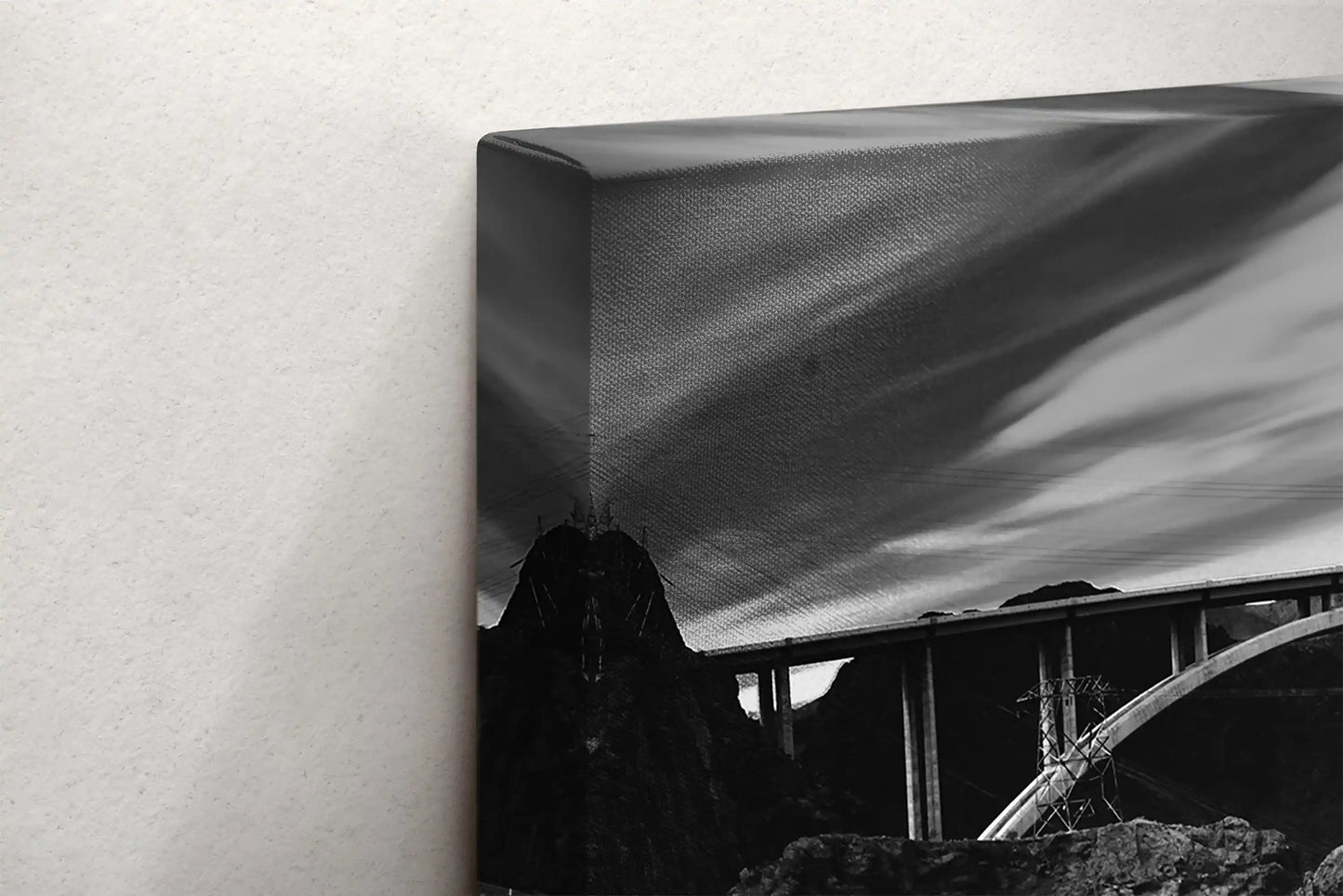 Side view of a black and white canvas print depicting Hoover Dam, showcasing the texture of the canvas wrap.