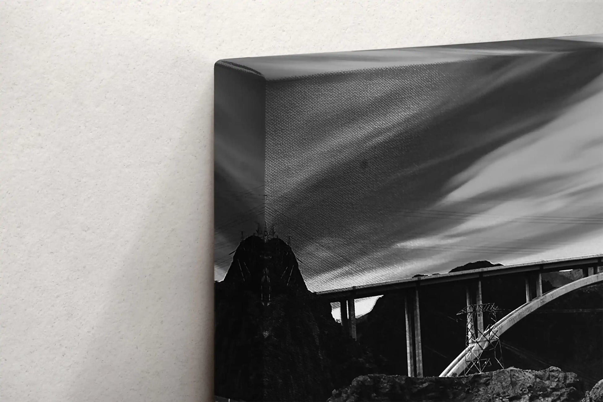 Side view of a black and white canvas print depicting Hoover Dam, showcasing the texture of the canvas wrap.