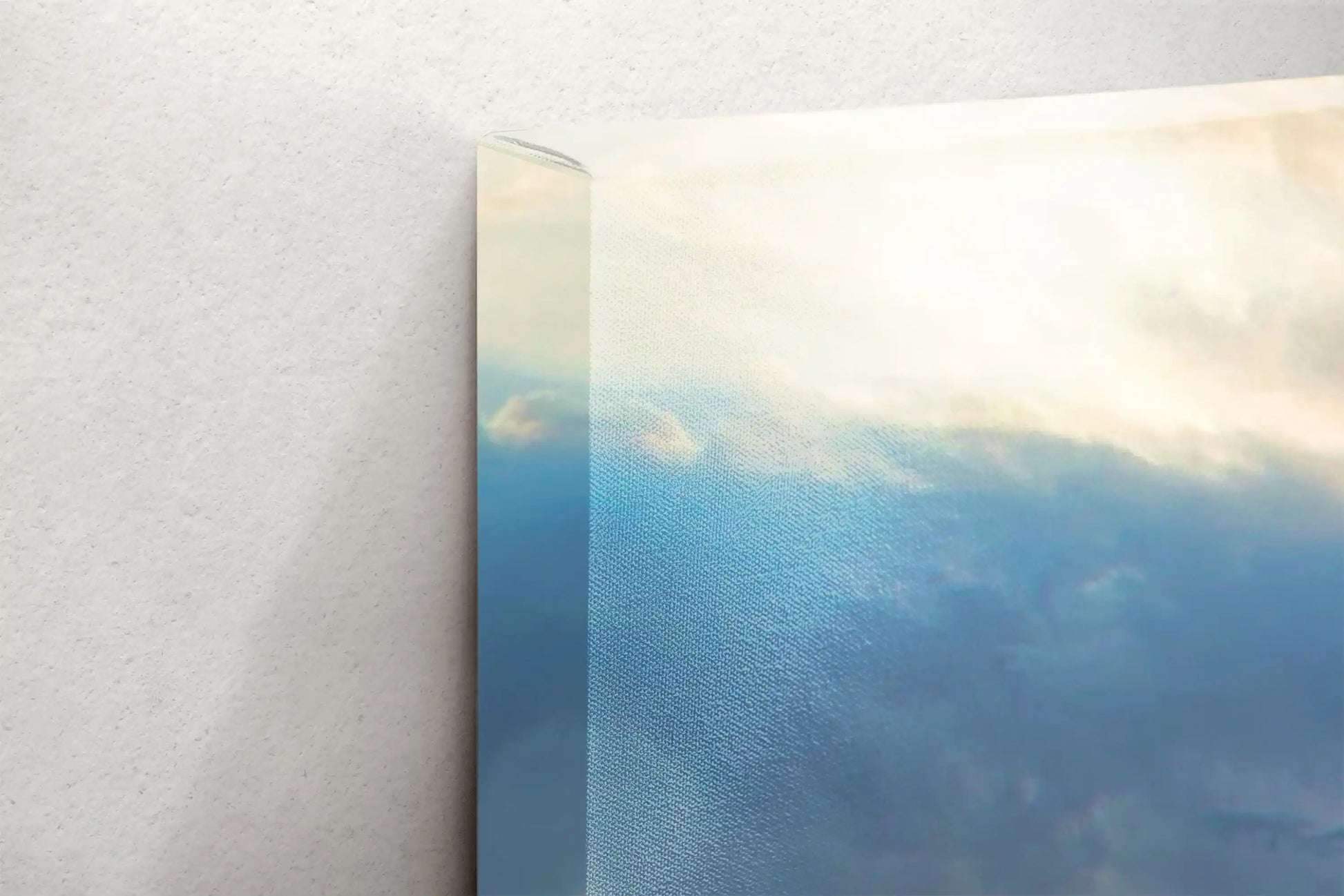 Close-up of a canvas print edge, revealing the image wrap and canvas texture, featuring soft sky hues.
