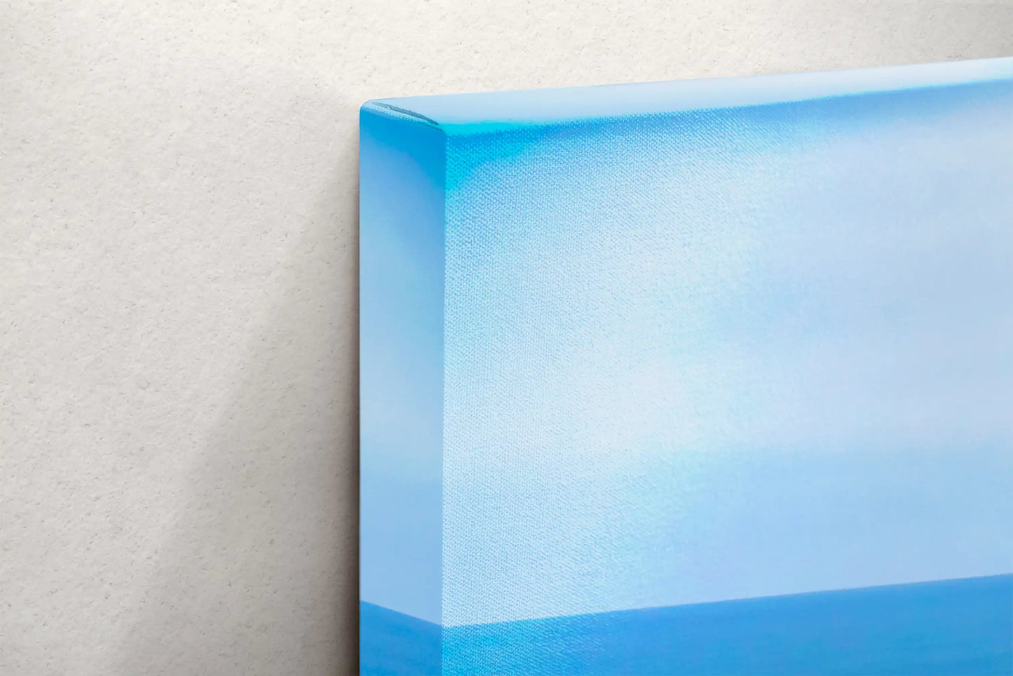 Close-up of the canvas edge of Point Lobos wall art, highlighting the seamless continuation of the ocean print.