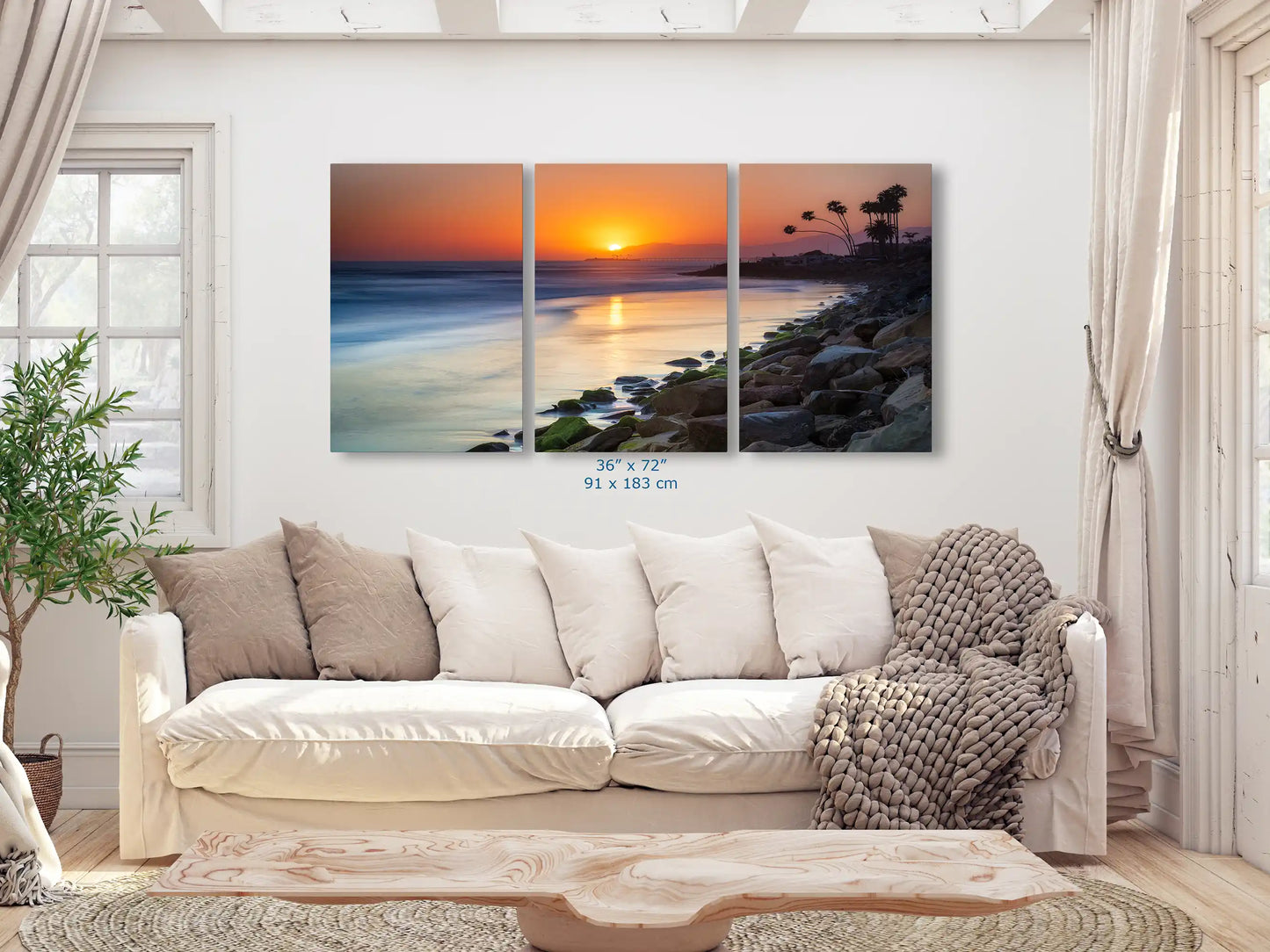 Large 36"x72" canvas print of Ventura Beach sunset, spanning across the living room wall for a dramatic visual impact.