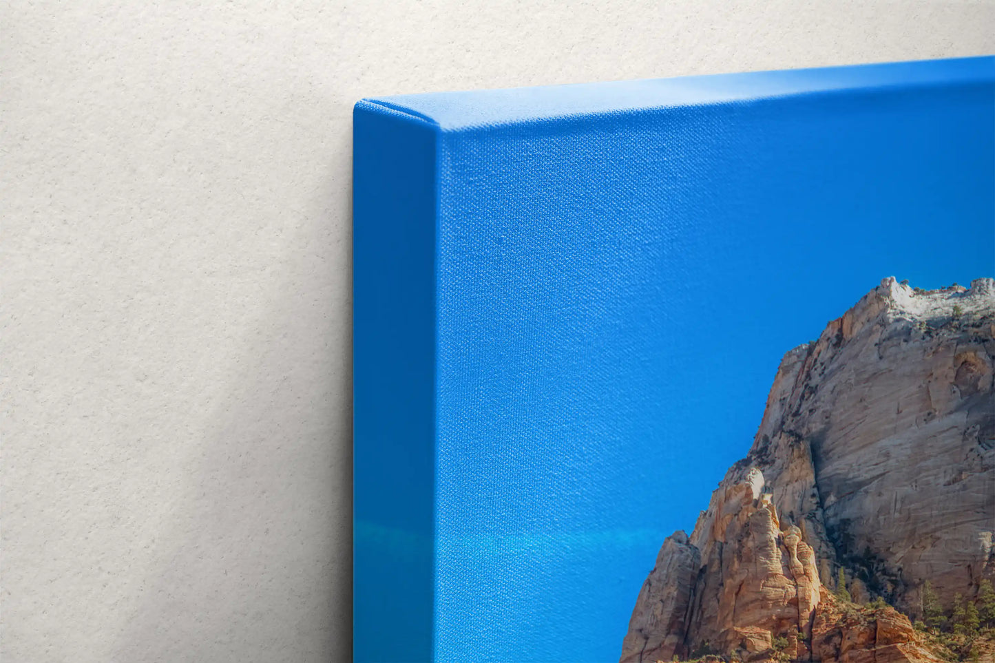 Close-up of the canvas texture and blue edges of a Zion Mountain wall art print, highlighting the print quality.