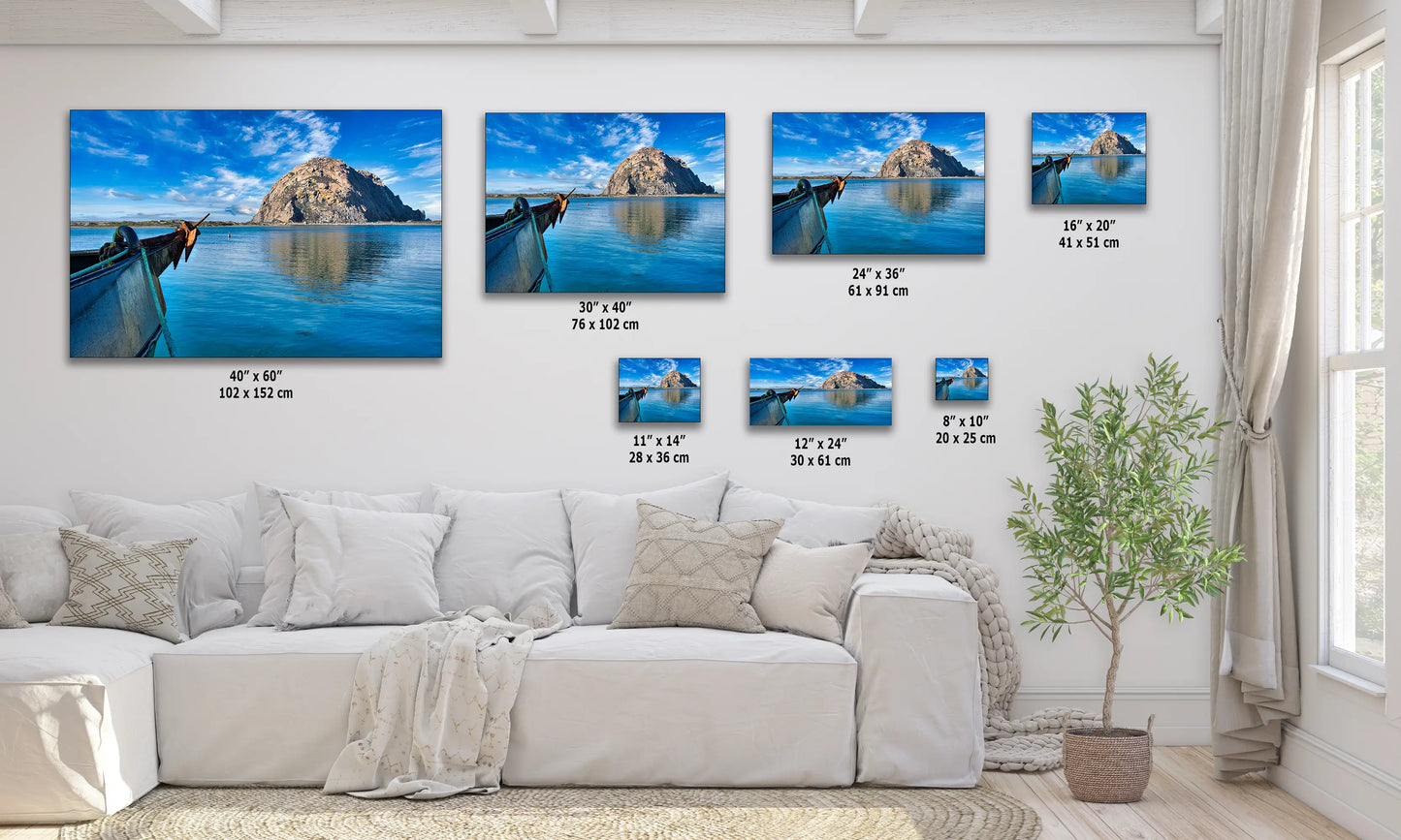 a living room with a white couch and paintings on the wall