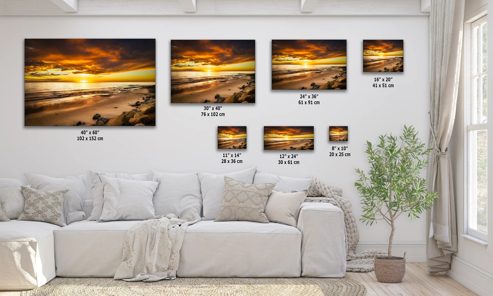 a living room with a white couch and four pictures on the wall