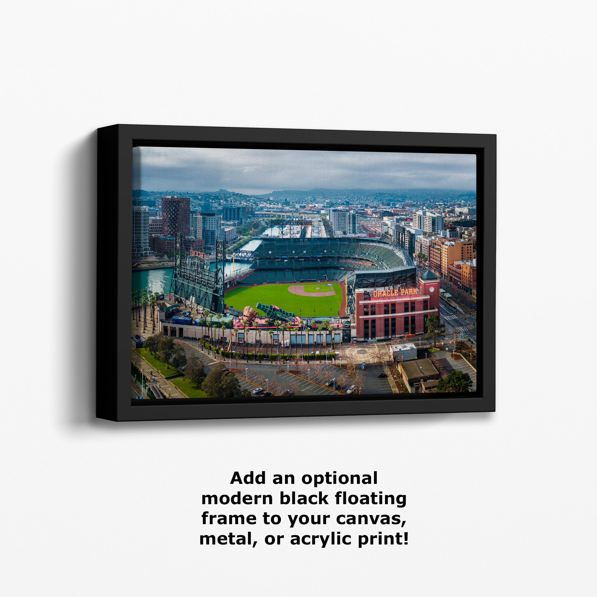 The image is a framed aerial view of a baseball stadium in a city, with surrounding buildings and infrastructure visible.