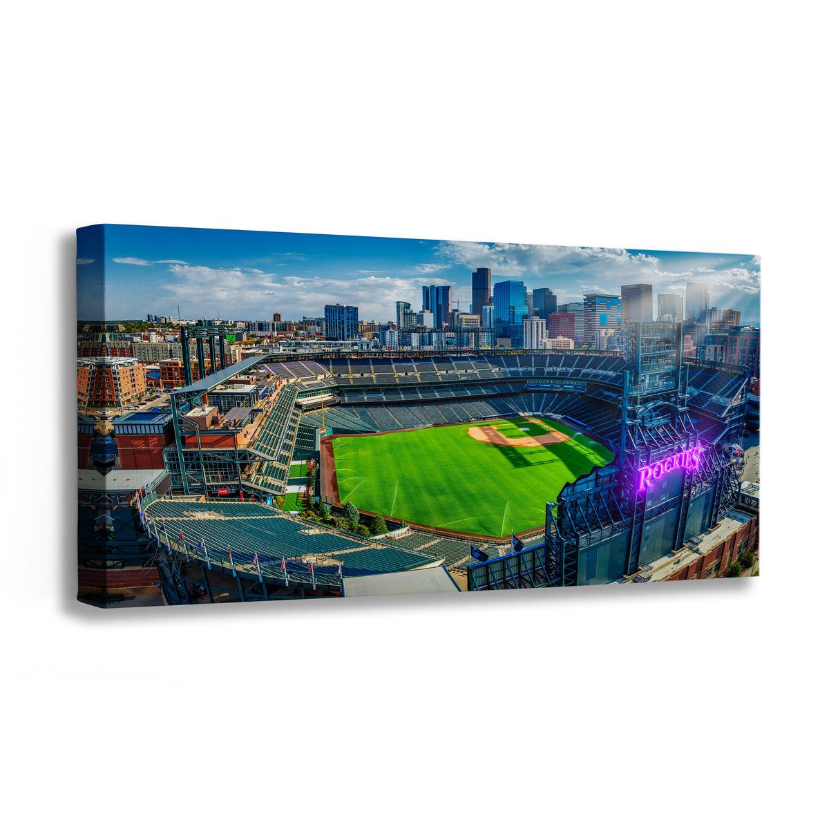 A wall art print showing an aerial view of the Colorado Rockies baseball stadium with the Denver city skyline in the background, photographed against a plain white studio background.