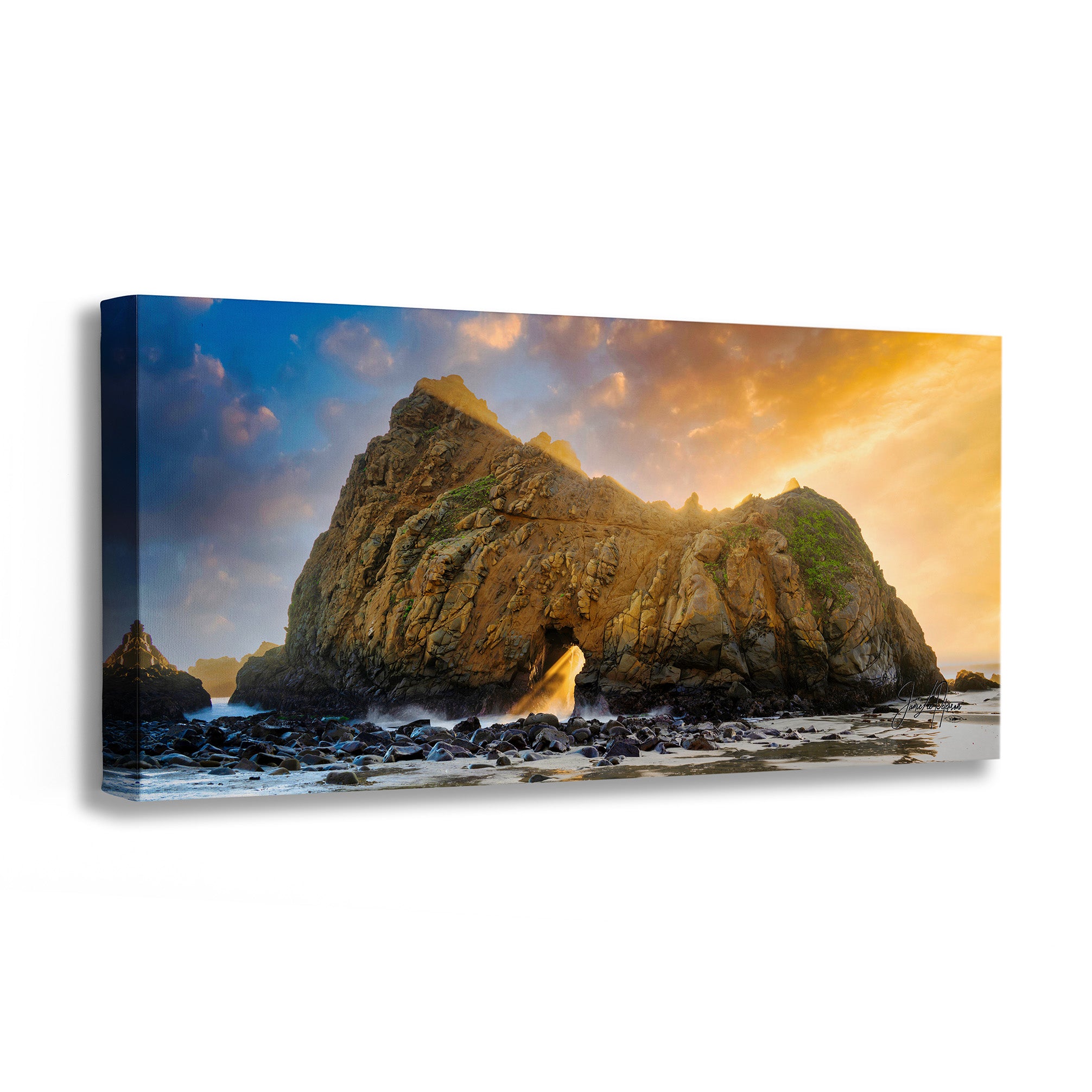 Canvas print of a coastal scene with a large rock formation and sunset sky.