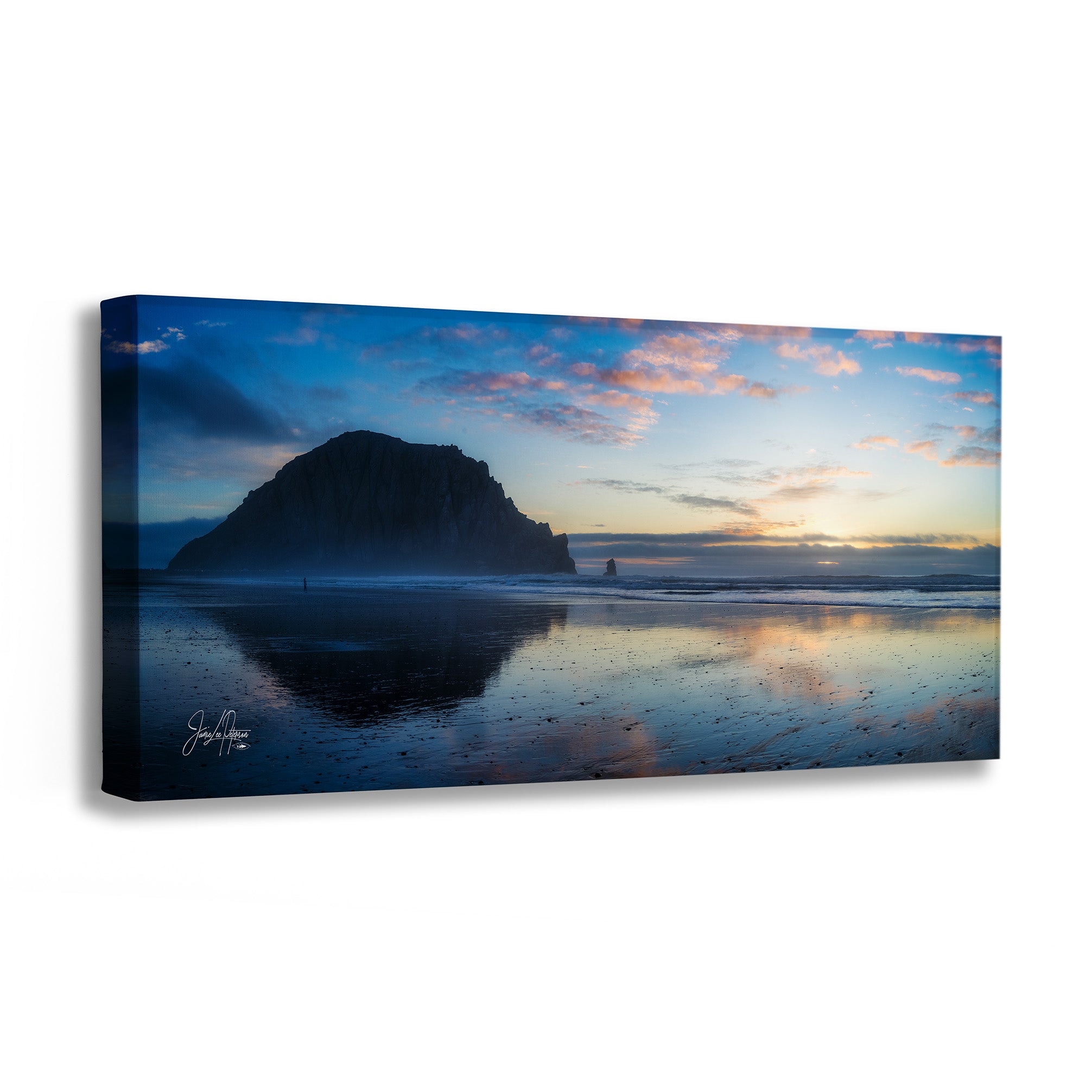 Canvas print of a beach scene with a large rock and sunset reflection on water.