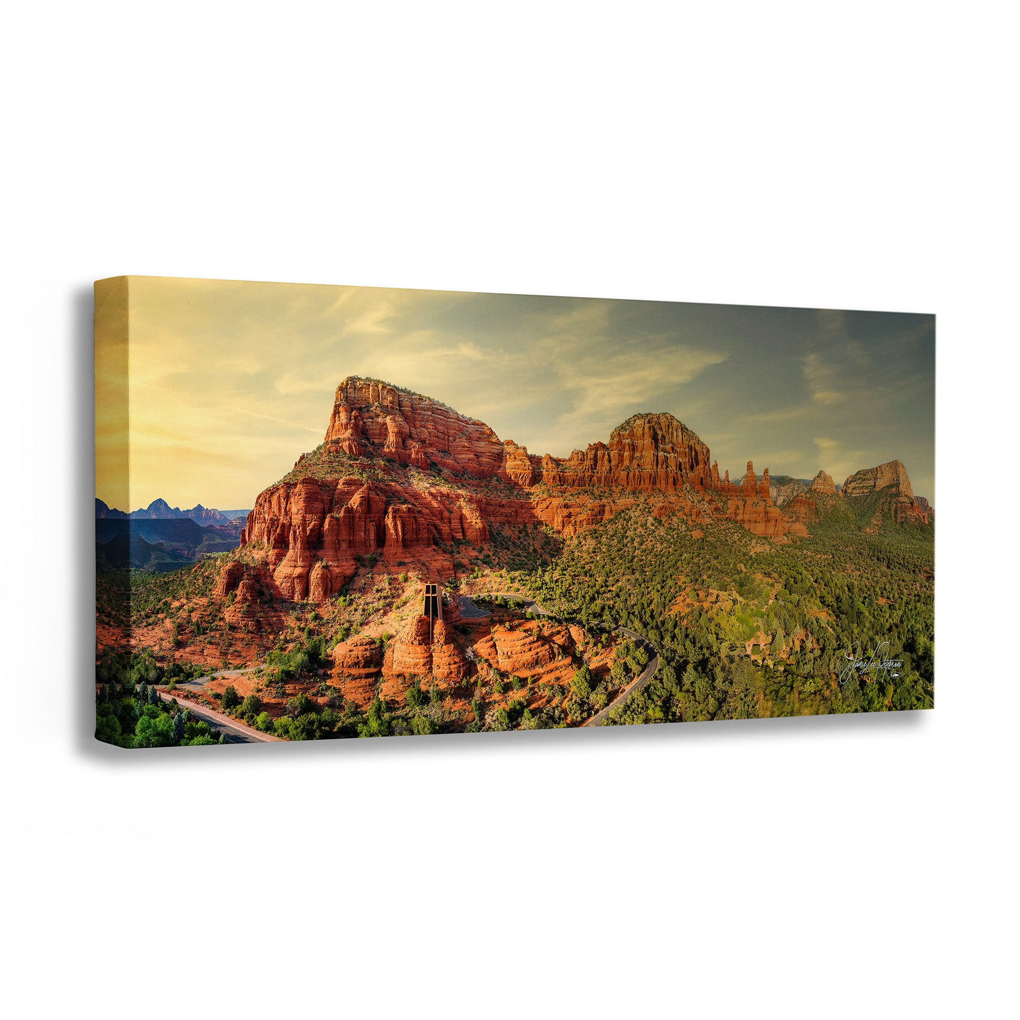 Canvas print of a scenic landscape with red rock formations and greenery.